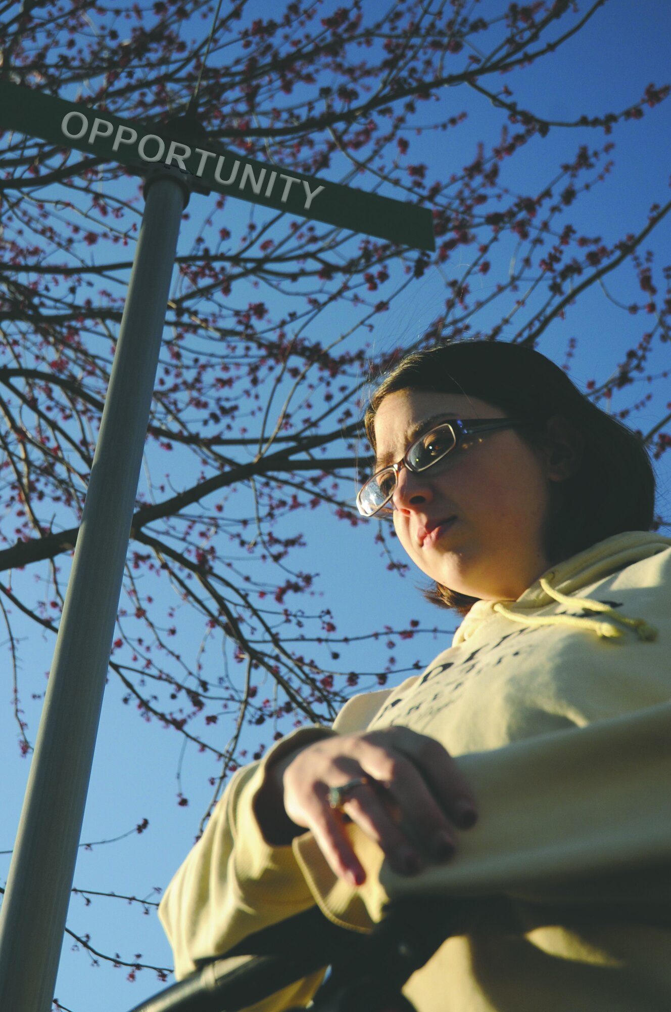 A woman stands outside.