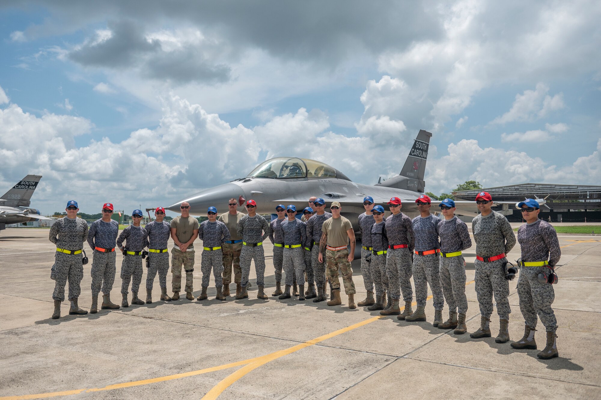 Airmen and F-16 fighter jets from the South Carolina Air National Guard’s 169th Fighter Wing and members of the Colombian Air Force pause for a photo Aug. 30, 2022, during the two-week Relampago VII exercise in Barranquilla, Colombia. South Carolina and Colombia are partners under the Department of Defense National Guard Bureau State Partnership Program.
