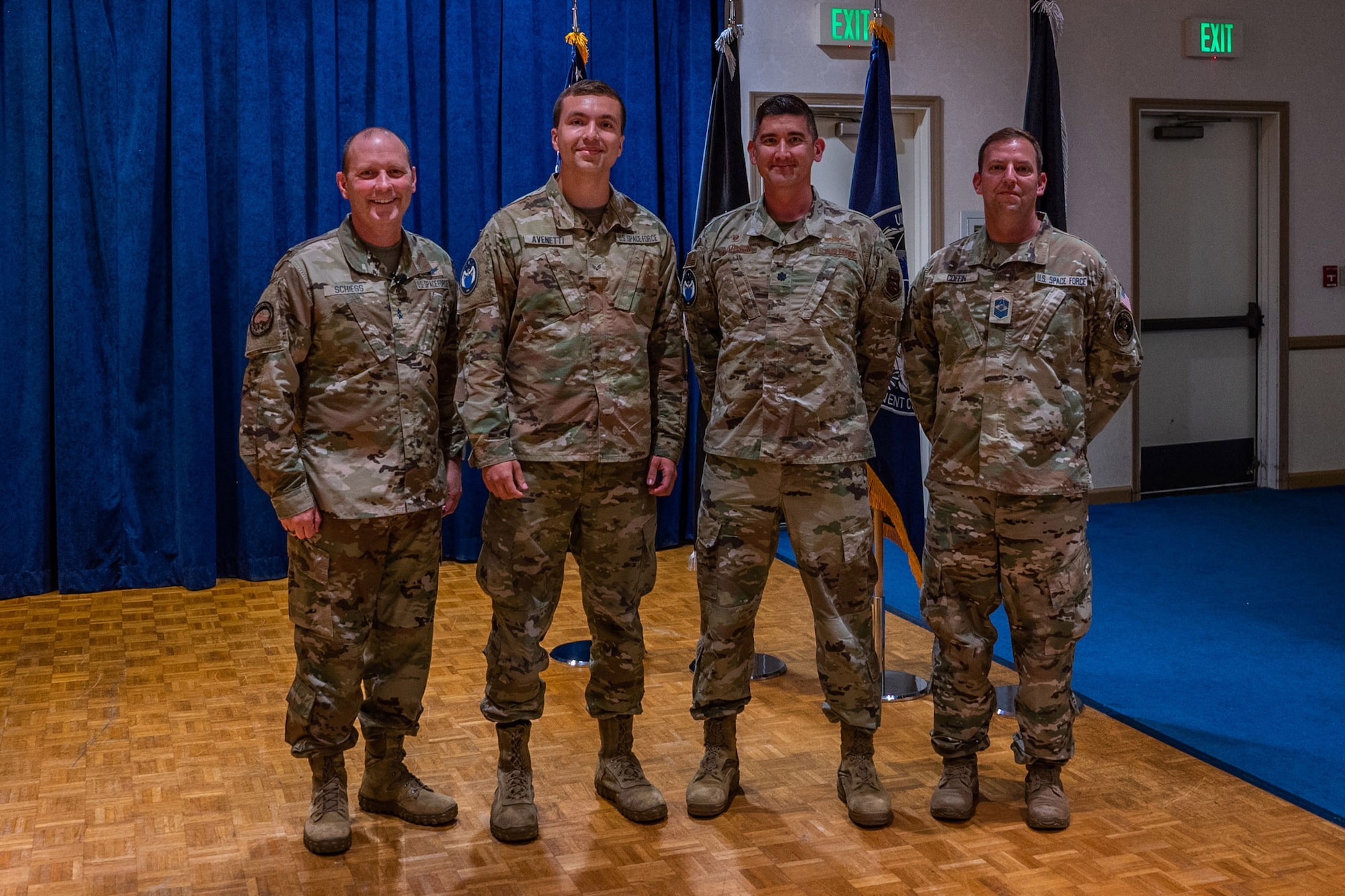 Spec 4. Derek Avenetti, 65th Cyberspace Squadron (CYS) cyber operator, middle left, stands with Combined Force Space Component Command (CFSCC) and 65 CYS leadership after getting coined at a CFSCC All Call Aug. 30, 2022, at Vandenberg Space Force Base, Calif. Unable to attend the All Call was Spec. 3 Jesse Hayden, also a 65 CYS cyber operator, who also was recognized and awarded a coin for his contributions performing life-saving efforts with Avenetti to a military member during a physical training test Aug. 16, 2022. (U.S. Space Force photo by Tech. Sgt. Luke Kitterman)