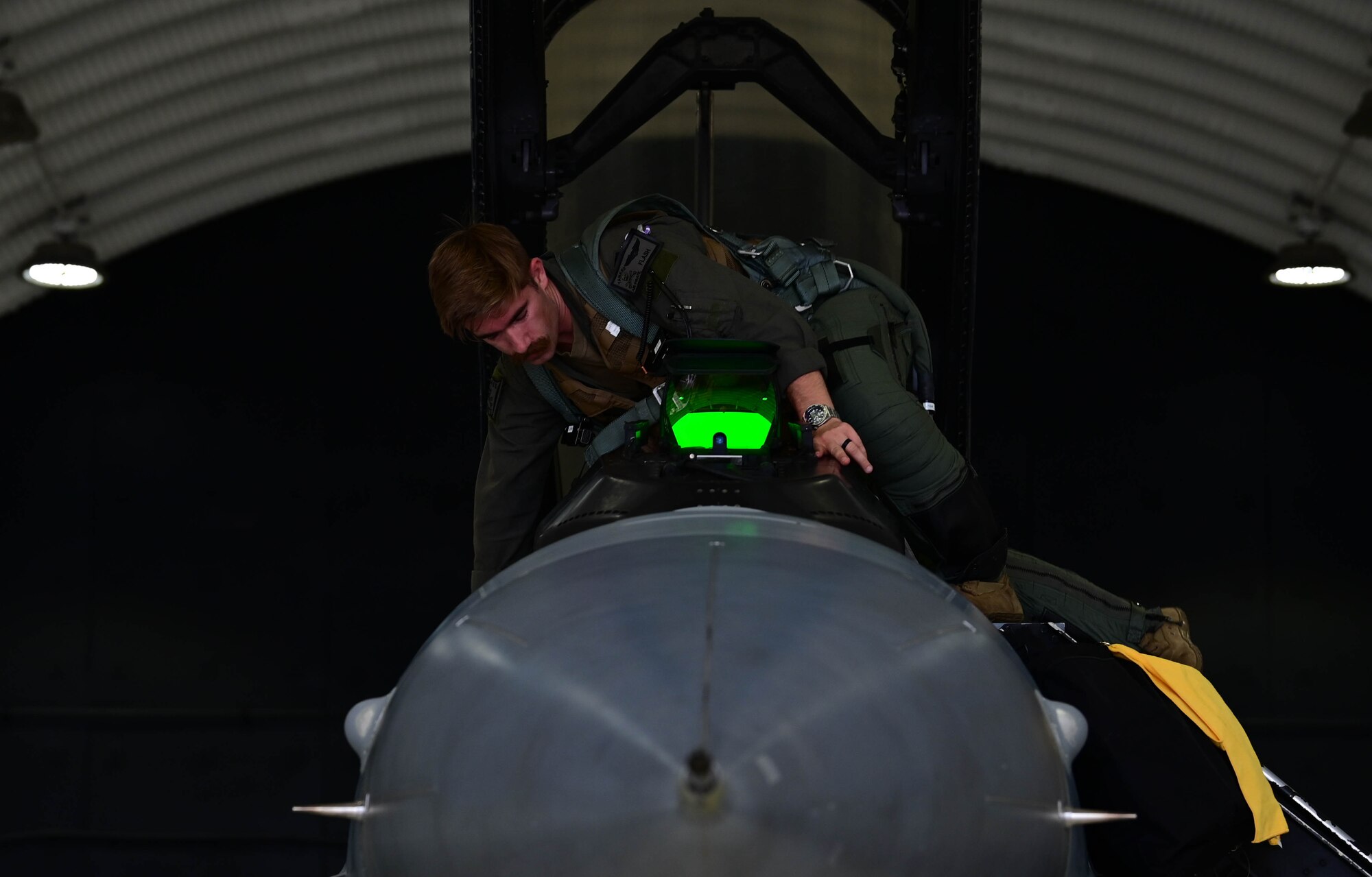 Man climbs into aircraft cockpit.