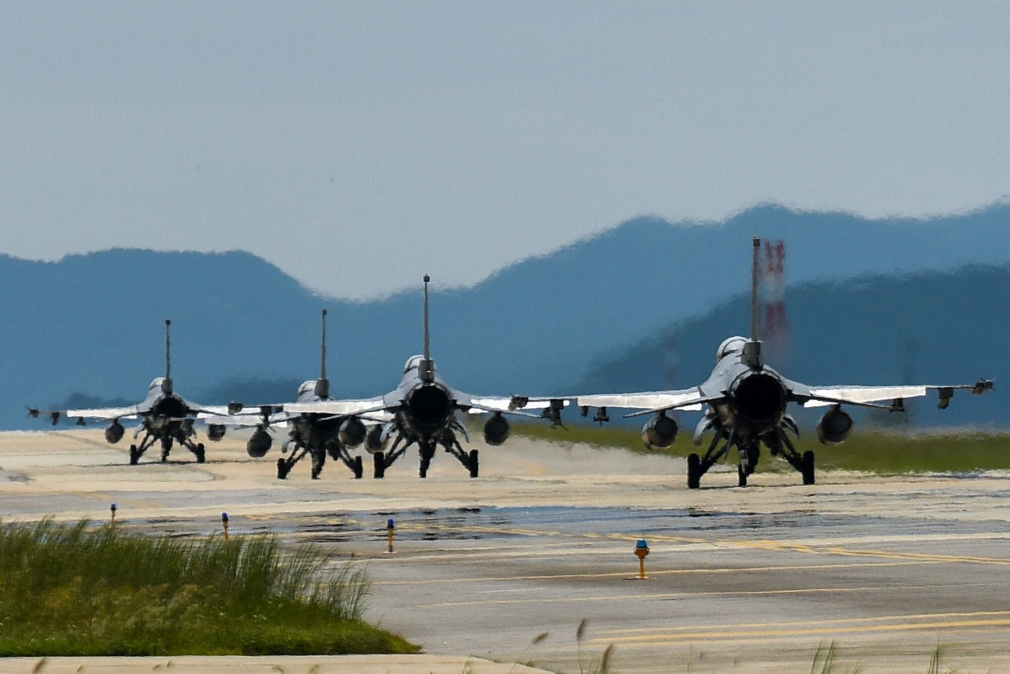 Aircraft taxiing down runway.
