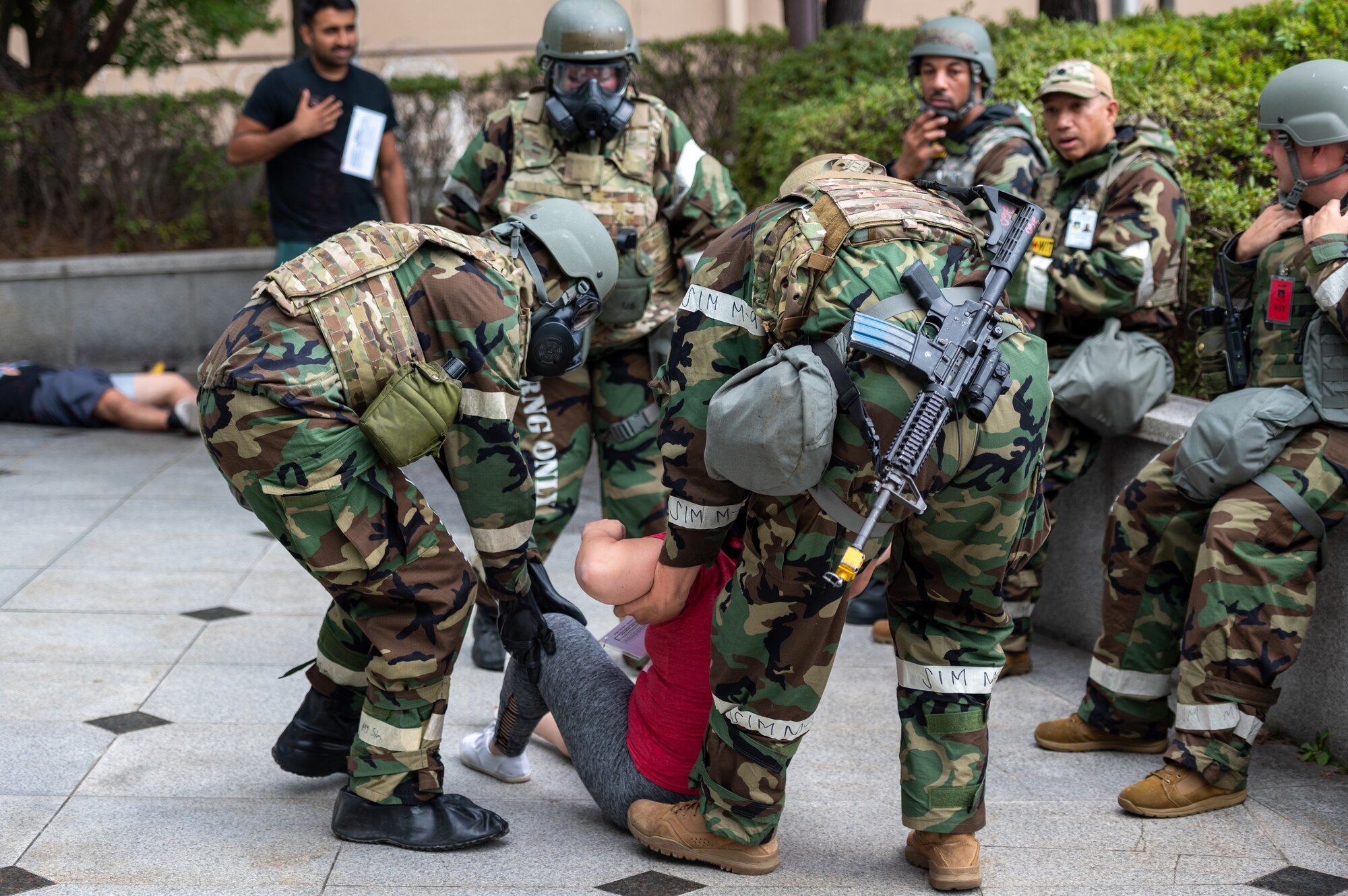 First responders assigned to the 51st Security Forces Squadron, move a simulated trauma victim to a safe extraction point during a mass casualty response training