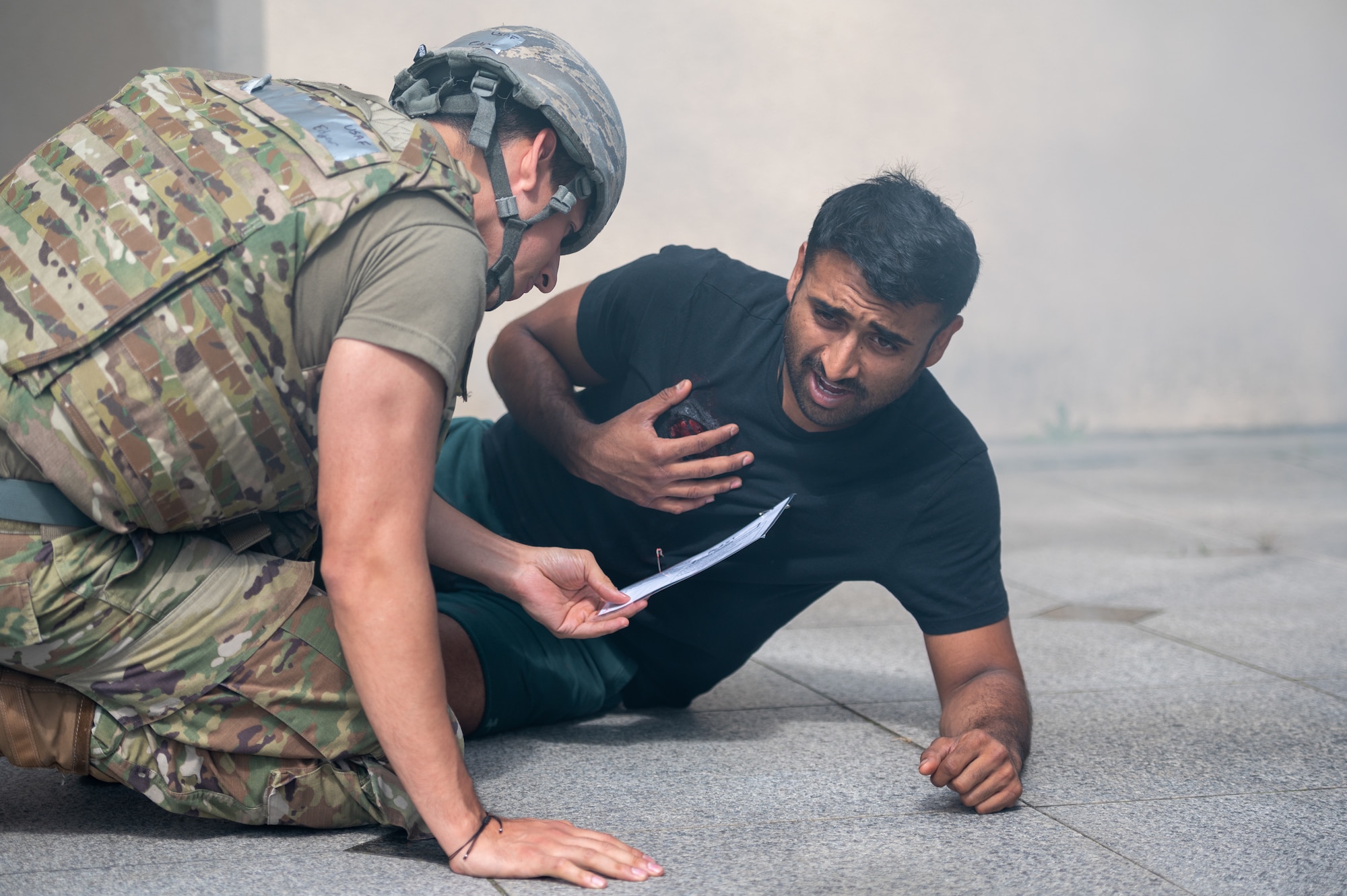 U.S. Air Force Staff Sgt. Visha Patel (right), 36th Fighter Generation Squadron simulated trauma victim, is assessed by U.S. Air Force Tech. Sgt. Edgar Corona, 51st Medical Group emergency medical technician, during a mass casualty response training