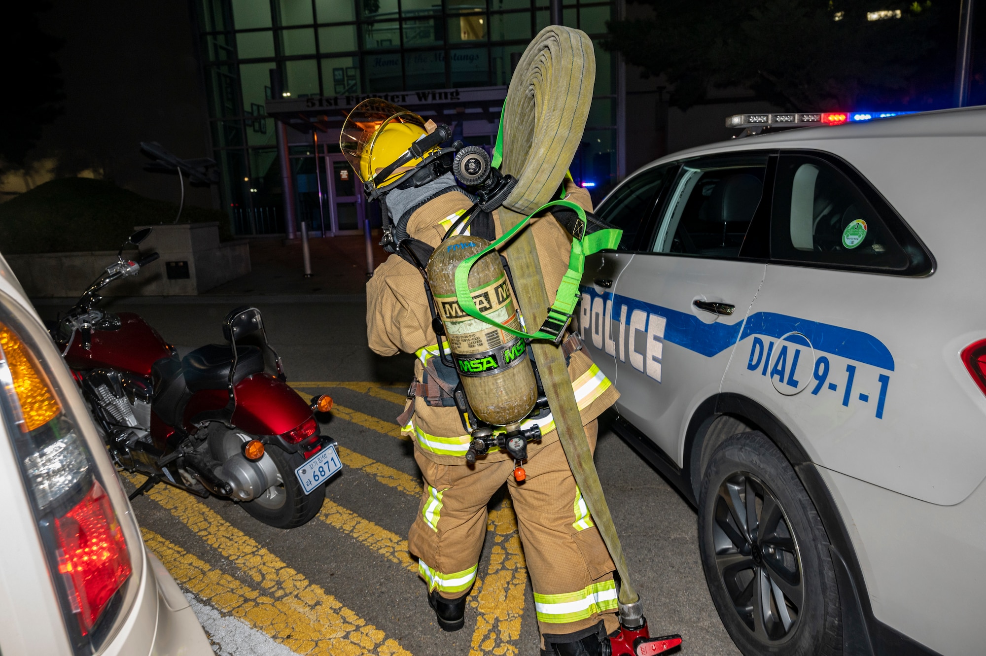 U.S. Air Force Airman 1st Class Joey Vue, 51st Civil Engineer Squadron firefighter, carries a hose during a fire response training scenario at Osan Air Base, Republic of Korea, Sept. 14, 2022.