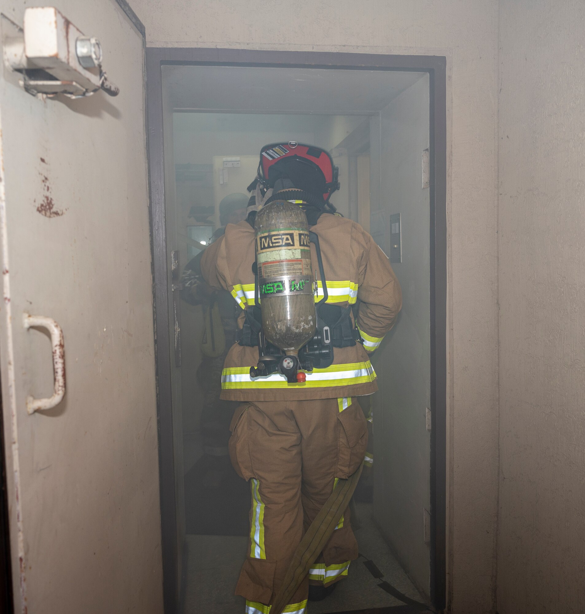 U.S. Air Force Staff Sgt. Larry McIver, 51st Civil Engineer Squadron lead firefighter, enters a simulated burning building fire response training scenario at Osan Air Base, Republic of Korea, Sept. 14, 2022.
