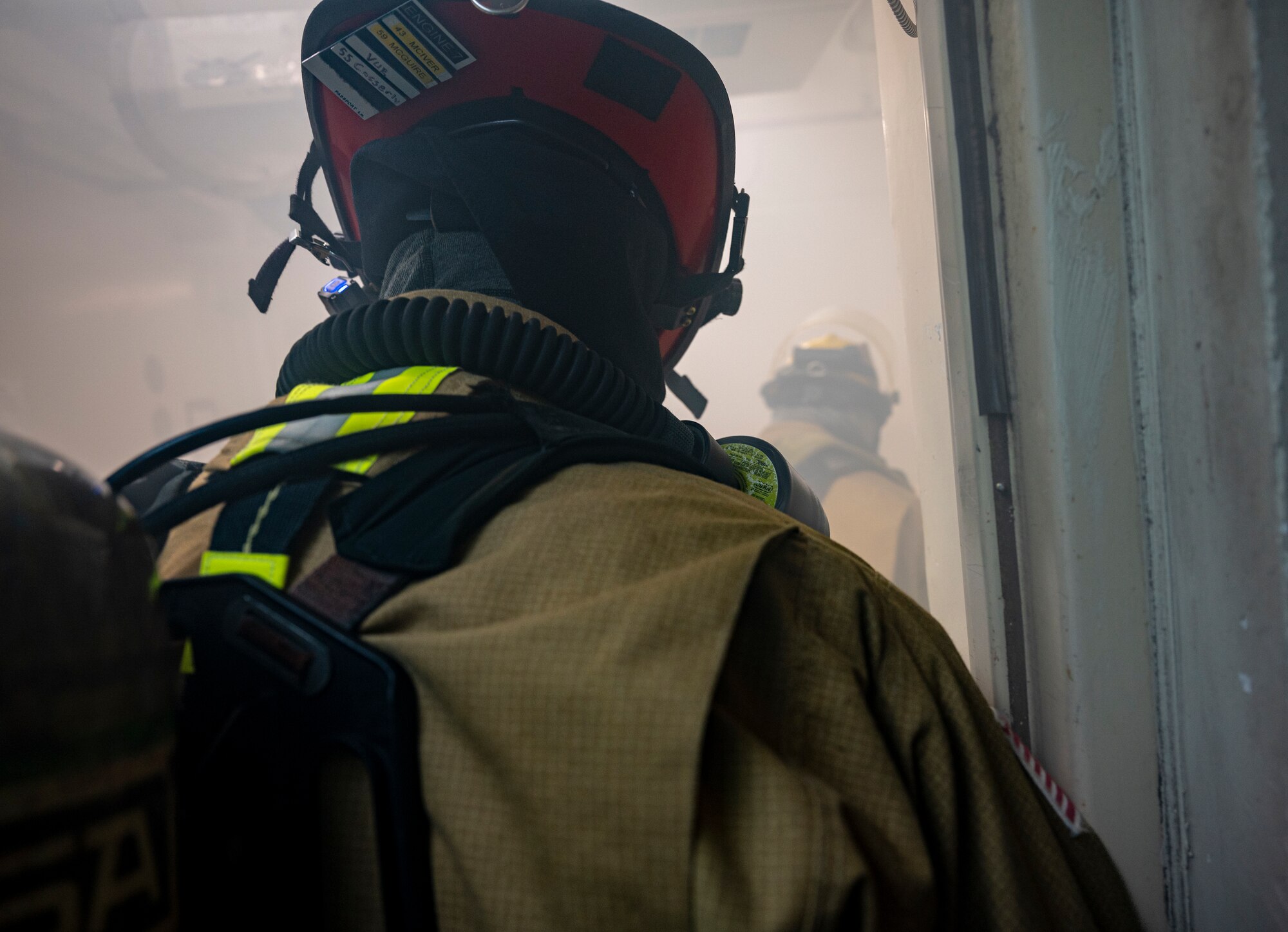 U.S. Air Force Firefighters assigned to the 51st Civil Engineer Squadron, enter a smoke-filled building during a fire response training scenario at Osan Air Base, Republic of Korea, Sept. 14, 2022.