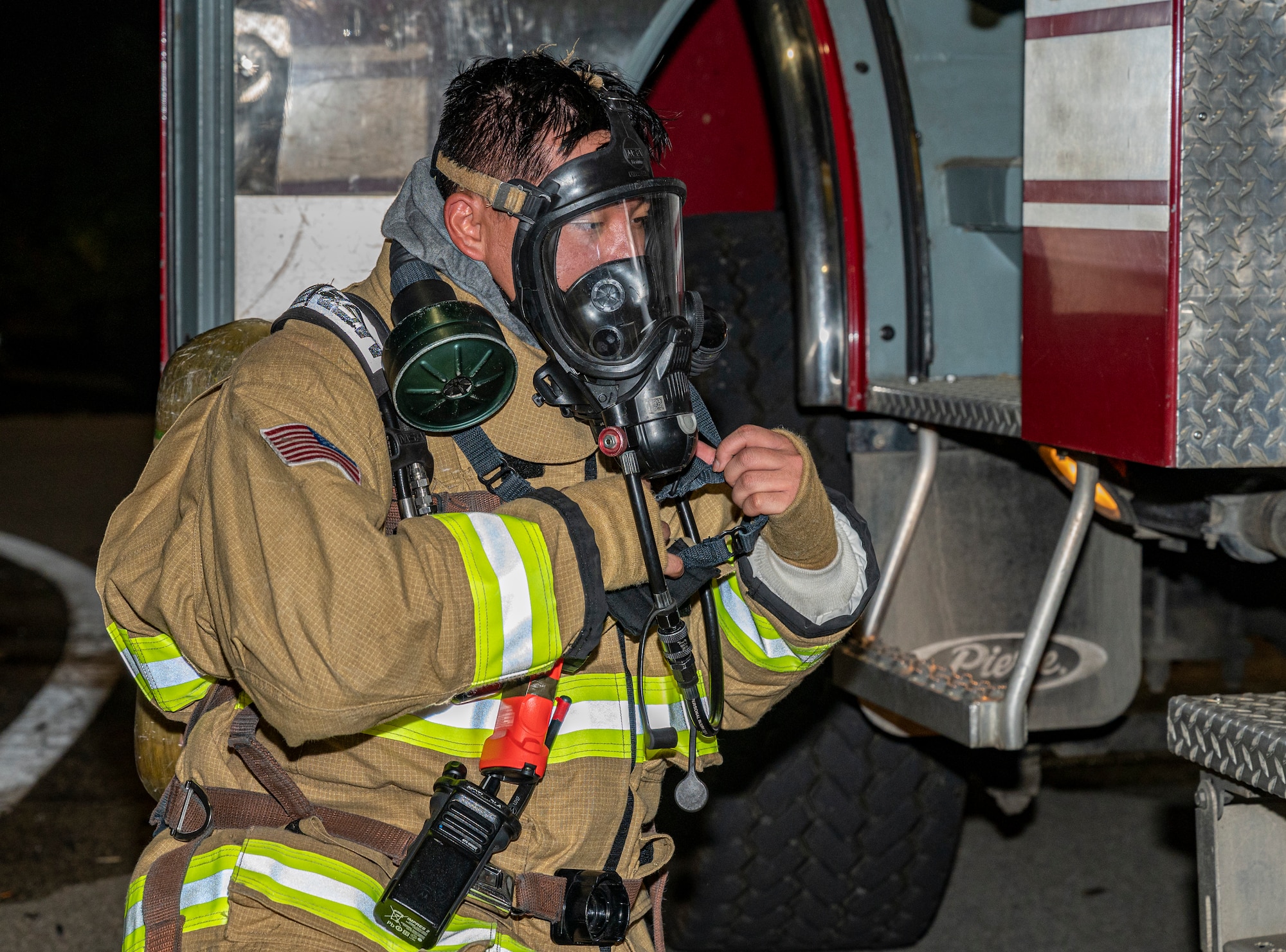 U.S. Air Force Airman 1st Class Joey Vue, 51st Civil Engineer Squadron (CES) firefighter, removes his gear after a fire response training scenario at Osan Air Base, Republic of Korea, Sept. 14, 2022.