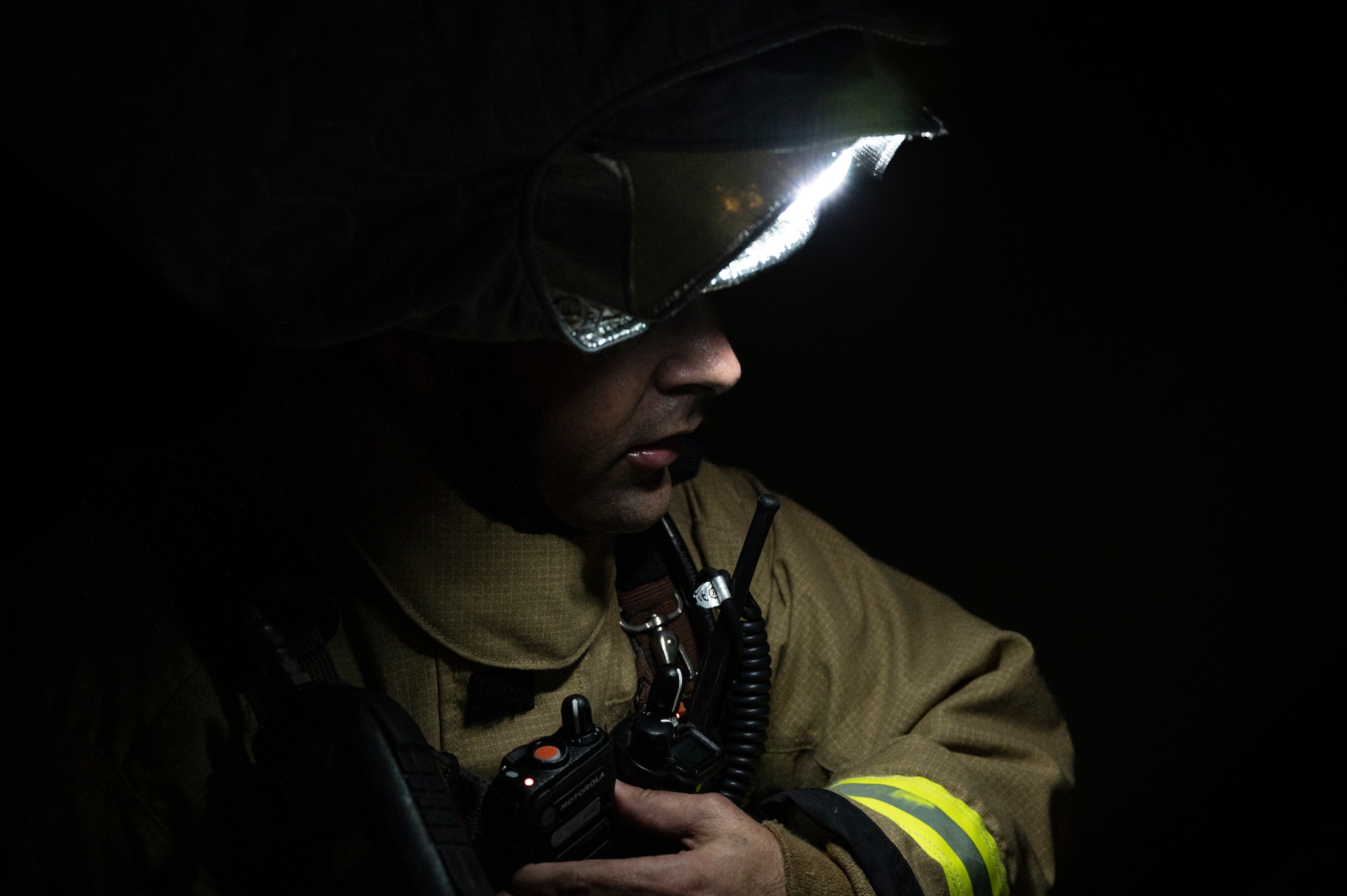 U.S. Air Force Staff Sgt. Larry McIver, 51st Civil Engineer Squadron lead firefighter, responds to radio traffic during a fire response training scenario at Osan Air Base, Republic of Korea, Sept. 14, 2022.