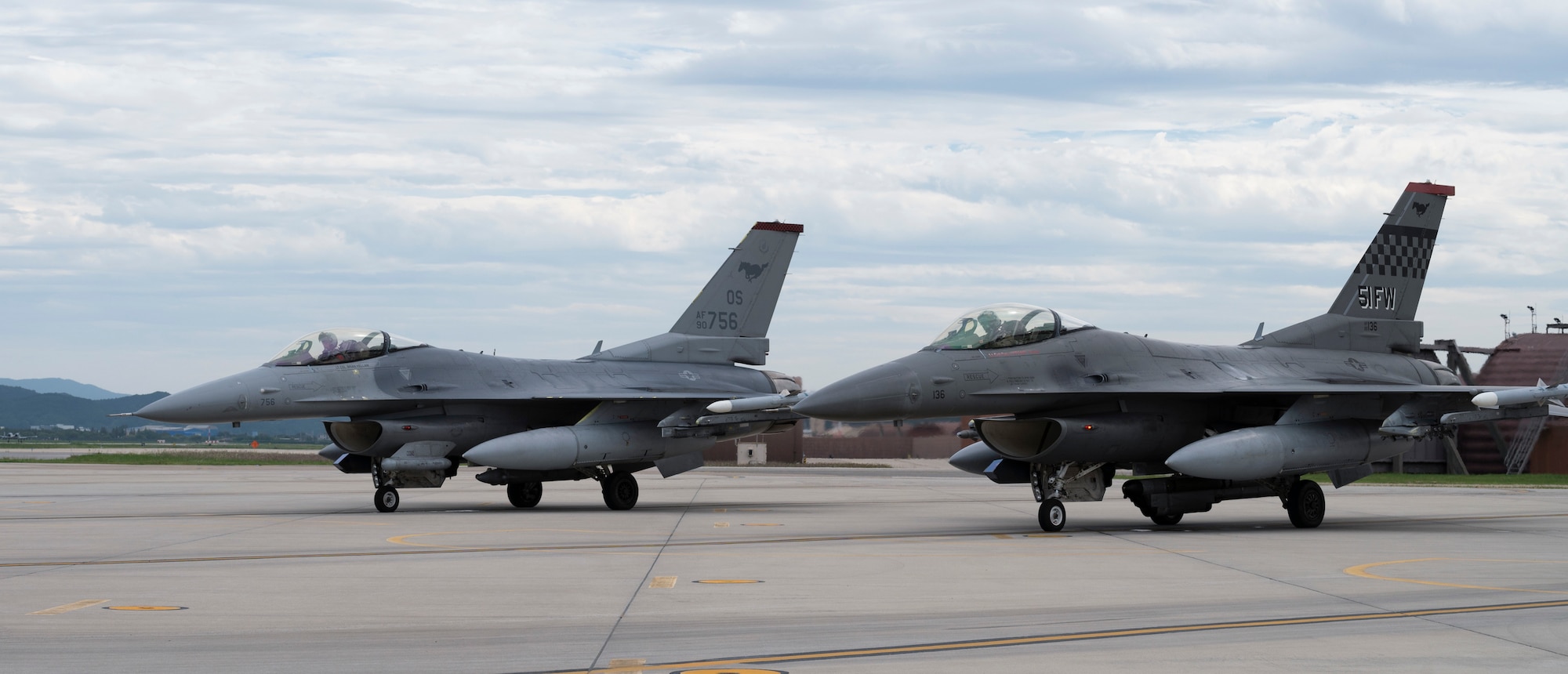Two F-16 Fighting Falcons assigned to the 36th Fighter Squadron wait to take-off on the alternate landing strip (ALS) prior to flying a training sortie.