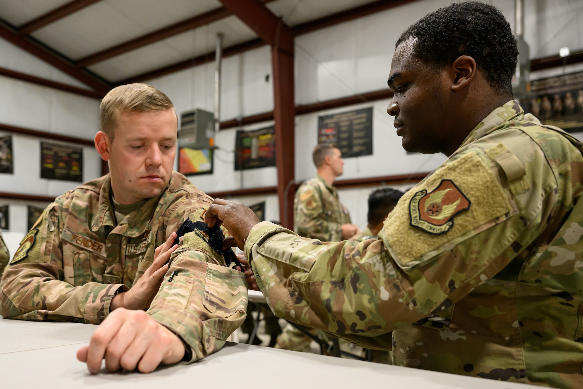 Right, Airman Samuel Andrews and Tech. Sgt. Kraig Fender, 75th Air Base Wing, practice self-aid and buddy care techniques during an Ability to Survive and Operate rodeo (ATSO) at Hill Air Force Base, Utah, Sept. 13, 2022.