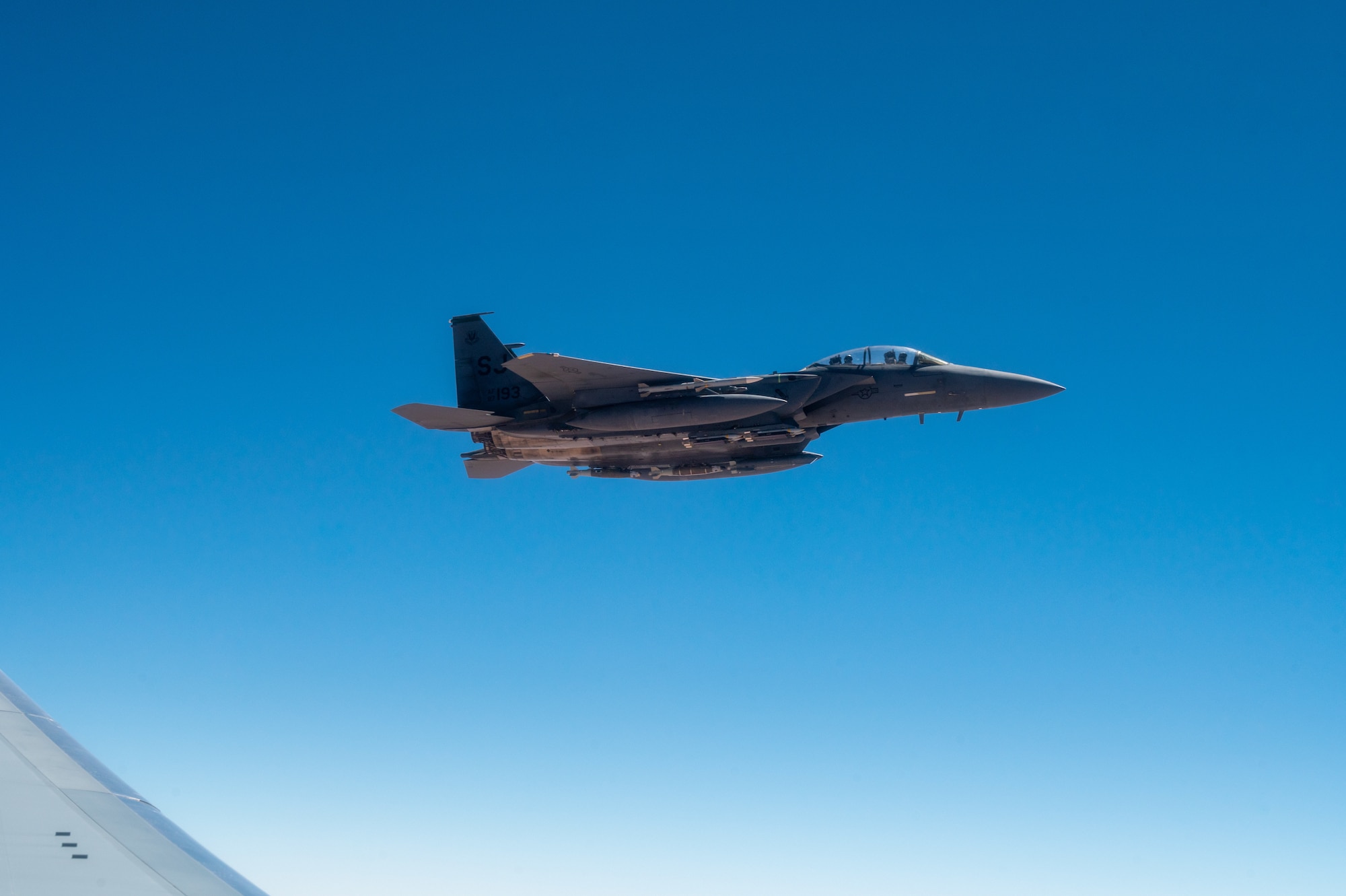 A U.S. Air Force F-15E Strike Eagle assigned to the 335th Expeditionary Fighter Squadron flies alongside a McConnell 22nd Air Refueling Wing KC-46A Pegasus Aug. 29, 2022, in the U.S. Central Command area of responsibility.