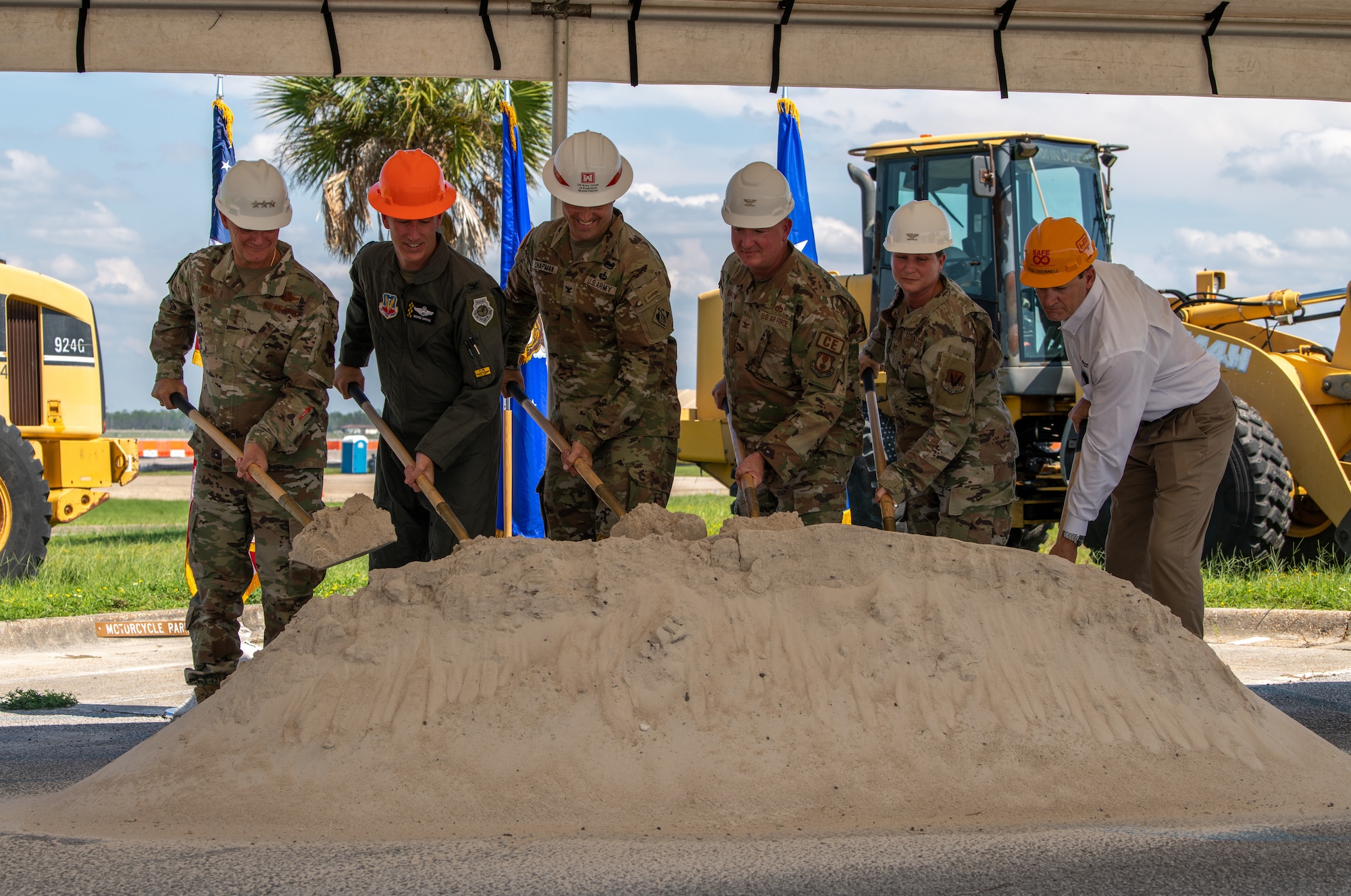 Group breaks soil with shovels