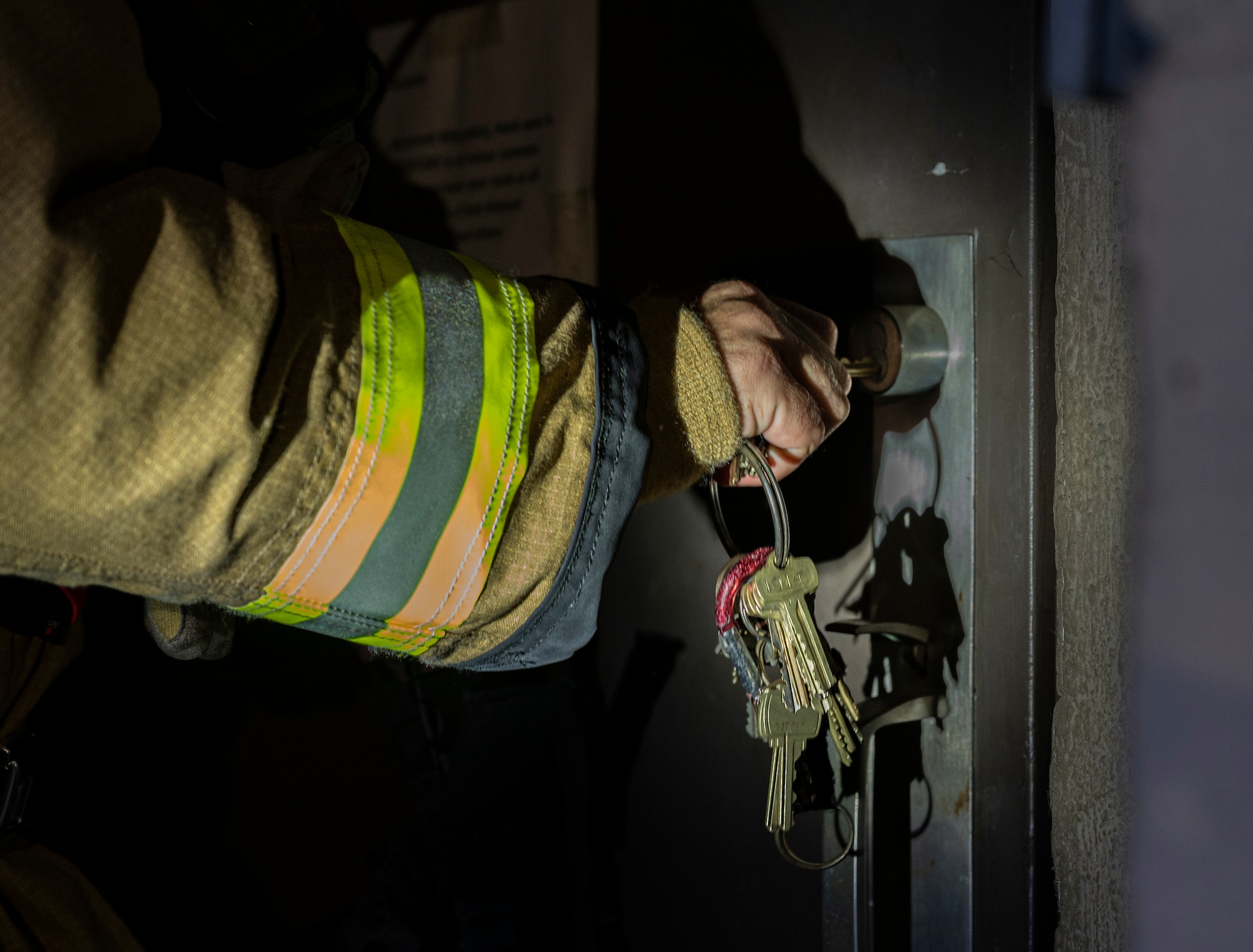 U.S. Air Force Staff Sgt. Larry Mciver, 51st Civil Engineer Squadron lead firefighter, opens the door to a simulated burning building during a wing training event at Osan Air Base, Republic of Korea, Sept. 14, 2022.