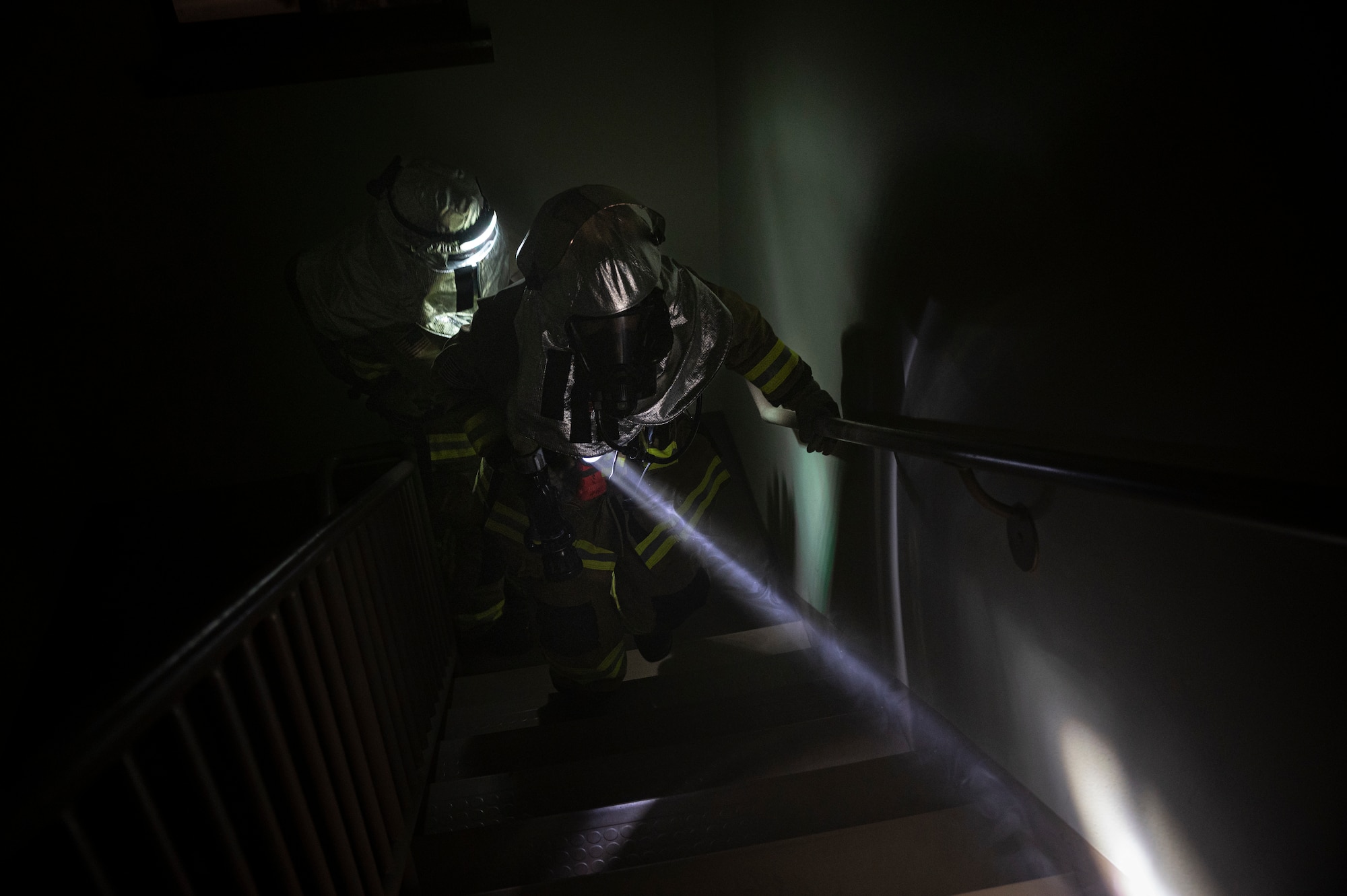 U.S. Air Force Airman 1st Class Joey Vue and U.S. Air Force Staff Sgt. Larry McIver, 51st Civil Engineer Squadron firefighters, enter a simulated burning building during a fire response training scenario at Osan Air Base, Republic of Korea, Sept. 14, 2022.