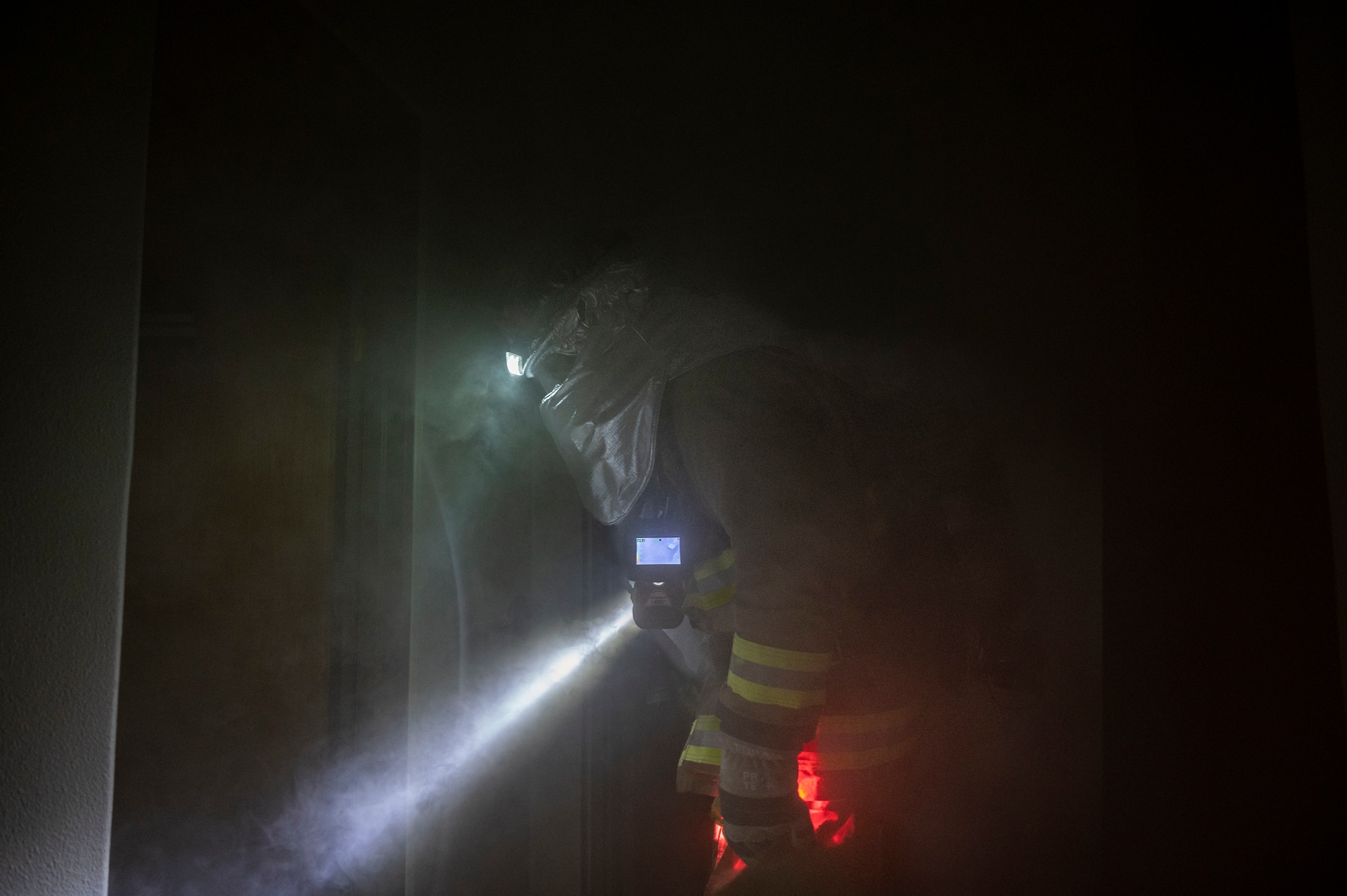 U.S. Air Force Airman 1st Class Joey Vue, 51st Civil Engineer Squadron (CES) firefighter, enters a smoke-filled building during a fire response training scenario at Osan Air Base, Republic of Korea, Sept. 14, 2022.