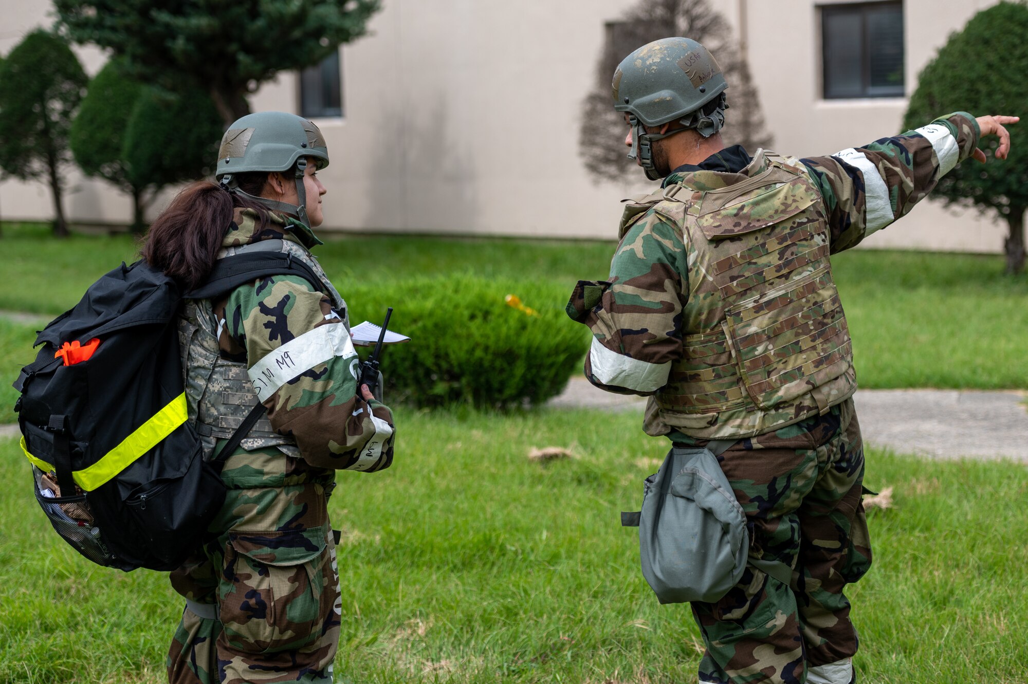U.S. Air Force Tech. Sgt. Antuoine Clowers 51st Force Support Squadron Wing Inspection Team member, (right), advises U.S. Air Force Senior Airman Nancy Prue (left), 51st Force Support Squadron shelter management team member, about proper procedures after discovering an unexploded ordnance (UXO) during a base-wide training event