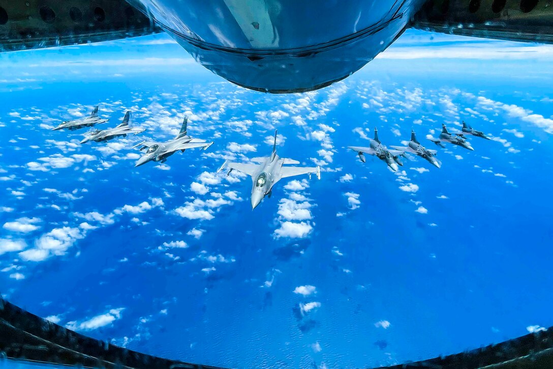 Eight aircraft fly in formation.