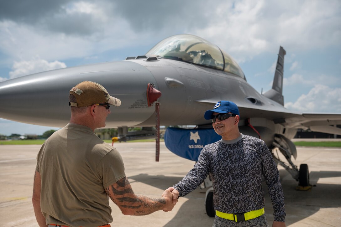 U.S. Air Force Staff Sgt. Justin Tatar from the South Carolina Air National Guard’s 169th Fighter Wing and a member of the Colombian Air Force greet each other during Relampago VII, Aug. 30, 2022, in Barranquilla, Colombia. The exercise focused on training techniques, tactics and procedures and strengthening interoperability between the U.S. and Colombian air forces.