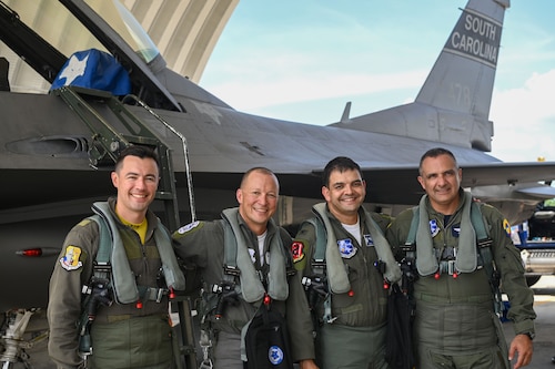U.S. Air Force Col. Quaid Quadri, center right, South Carolina Air National Guard’s 169th Fighter Wing commander, U.S. Air Force Lt. Col. Madison Woo, center left, South Carolina Air National Guard’s 157th Fighter Squadron commander, pause for a post-flight photo with Colombian Air Force Col. Pedro Vega, Air Combat Command commander, right, and Colombian Air Force’s 111th Fighter Squadron commander, Maj. Rommel Rodriguez, in front of an F-16 fighter jet during Relampago VII, an exercise in Barranquilla, Colombia, September 2, 2022. The purpose of this exercise is to provide the Colombian Air Force with requested realistic interoperability training as allied countries, under NATO standards. South Carolina is Colombia’s State Partner in the State Partnership Program. (U.S. Air National Guard photo by Senior Master Sgt. Carl Clegg, 169th Fighter Wing Public Affairs)