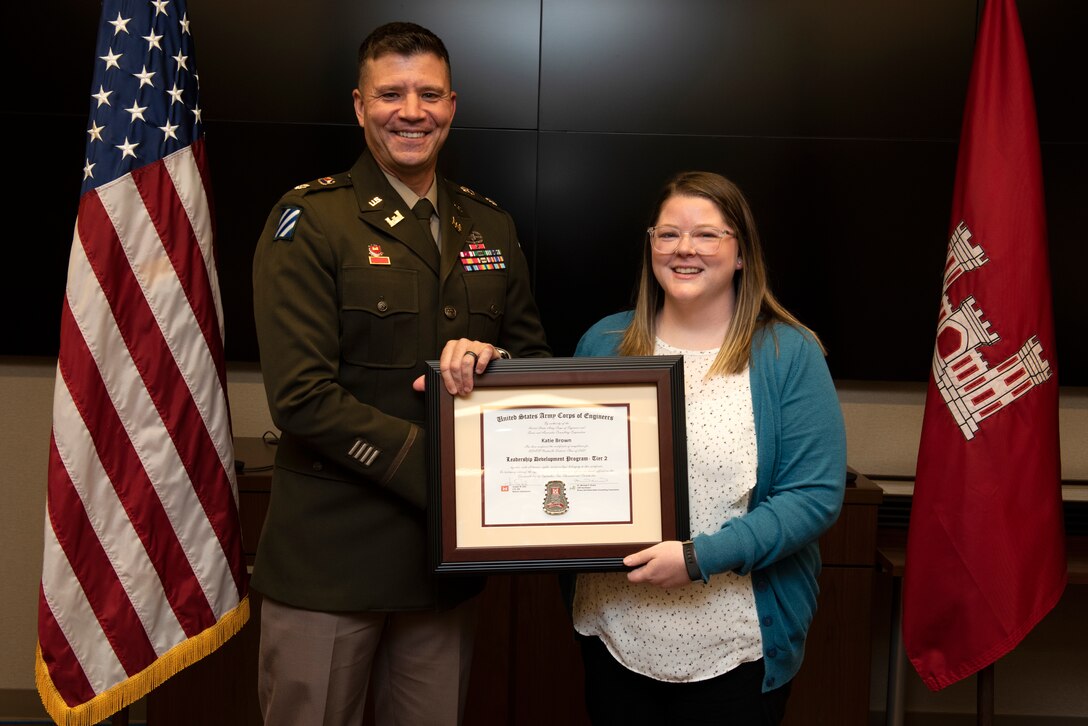 Katie Brown, U.S. Army Corps of Engineers Nashville District, receives a certificate of completion for the 2022 Leadership Development Program Level II Course from Lt. Col. Joseph Sahl, Nashville District commander, and Michael Evans, course instructor, during a graduation ceremony Sept. 14, 2022, at the district headquarters in Nashville, Tennessee. (USACE Photo by Lee Roberts)