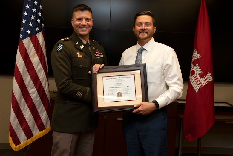 Cody Flatt, U.S. Army Corps of Engineers Nashville District, receives a certificate of completion for the 2022 Leadership Development Program Level II Course from Lt. Col. Joseph Sahl, Nashville District commander, and Michael Evans, course instructor, during a graduation ceremony Sept. 14, 2022, at the district headquarters in Nashville, Tennessee. (USACE Photo by Lee Roberts)