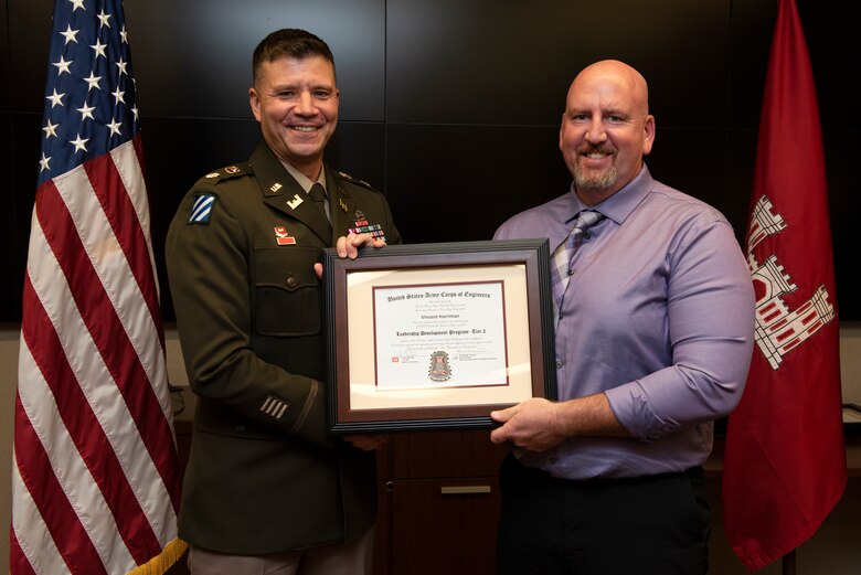 Vincent Harriman, U.S. Army Corps of Engineers Nashville District, receives a certificate of completion for the 2022 Leadership Development Program Level II Course from Lt. Col. Joseph Sahl, Nashville District commander, and Michael Evans, course instructor, during a graduation ceremony Sept. 14, 2022, at the district headquarters in Nashville, Tennessee. (USACE Photo by Lee Roberts)