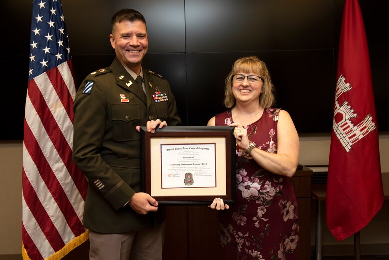 Renee Mach, U.S. Army Corps of Engineers Nashville District, receives a certificate of completion for the 2022 Leadership Development Program Level II Course from Lt. Col. Joseph Sahl, Nashville District commander, and Michael Evans, course instructor, during a graduation ceremony Sept. 14, 2022, at the district headquarters in Nashville, Tennessee. (USACE Photo by Lee Roberts)