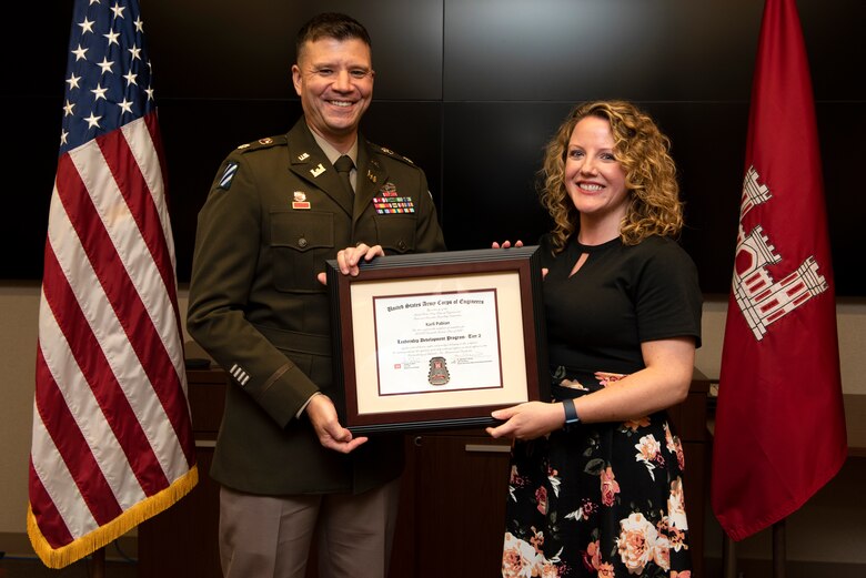 Karli Pabian, U.S. Army Corps of Engineers Nashville District, receives a certificate of completion for the 2022 Leadership Development Program Level II Course from Lt. Col. Joseph Sahl, Nashville District commander, and Michael Evans, course instructor, during a graduation ceremony Sept. 14, 2022, at the district headquarters in Nashville, Tennessee. (USACE Photo by Lee Roberts)