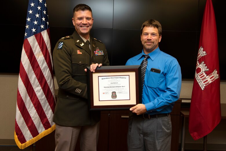 Jody Robinson, U.S. Army Corps of Engineers Nashville District, receives a certificate of completion for the 2022 Leadership Development Program Level II Course from Lt. Col. Joseph Sahl, Nashville District commander, and Michael Evans, course instructor, during a graduation ceremony Sept. 14, 2022, at the district headquarters in Nashville, Tennessee. (USACE Photo by Lee Roberts)