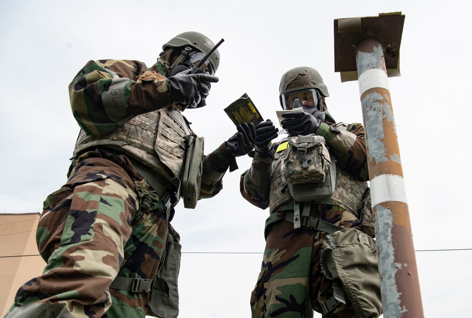 U.S. Air Force Senior Airman Joshua Crenshaw (left), and U.S. Air Force Staff Sgt. Frank McCall, 8th Healthcare Operations Squadron bioenvironmental engineering technicians, read a M265 detector kit during a training event at Kunsan Air Base, Republic of Korea, Sept. 14, 2022. The detector kit tests for various chemical warfare agents to help narrow down the type of chemical attack. (U.S. Air Force photo by Staff Sgt. Sadie Colbert)