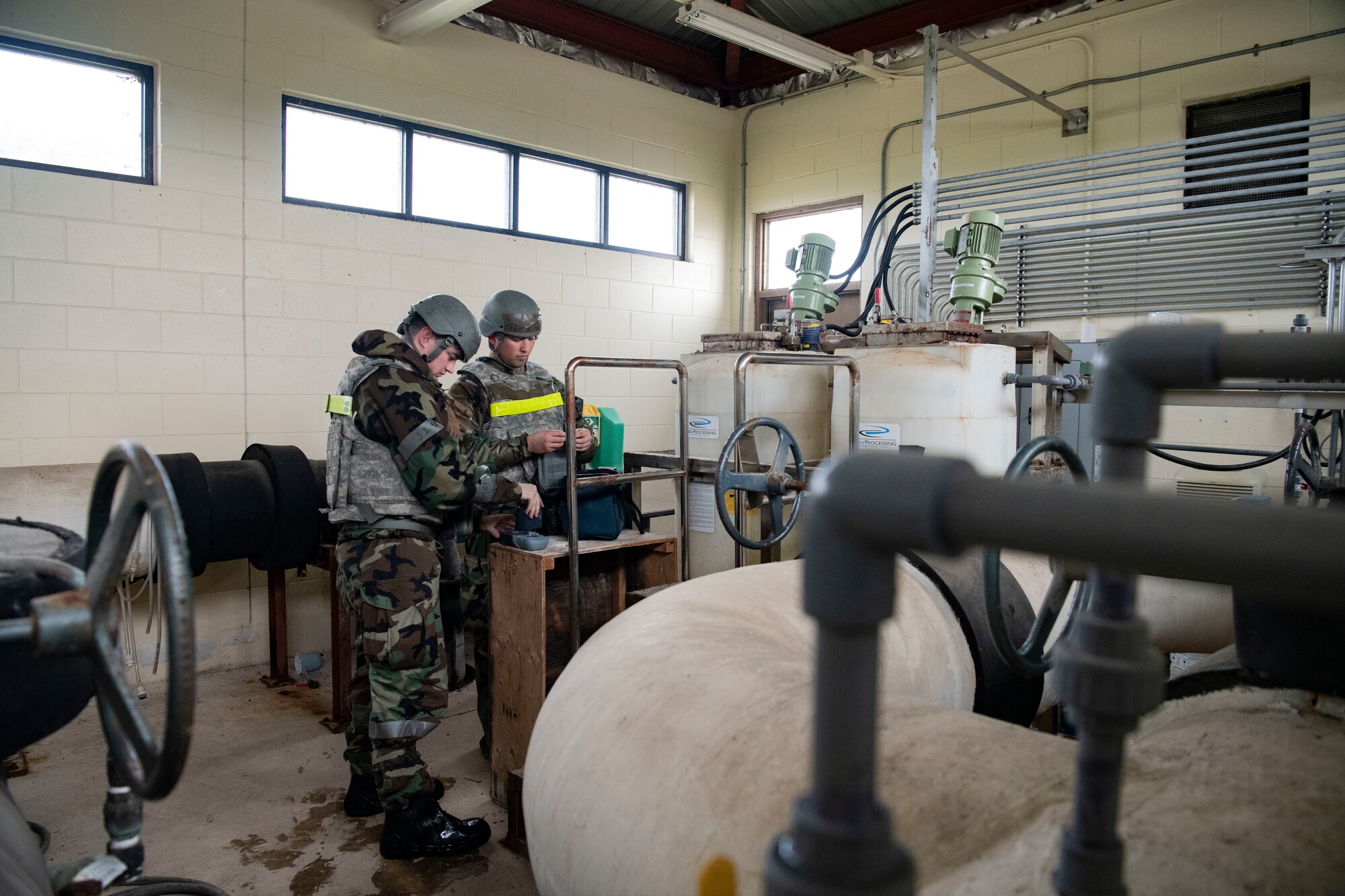 U.S. Air Force Senior Airman Joshua Crenshaw (left), and U.S. Air Force Staff Sgt. Frank McCall, 8th Healthcare Operations Squadron bioenvironmental engineering technicians, read a water sample during a training event at Kunsan Air Base, Republic of Korea, Sept. 14, 2022. Drinking water is monitored for correct pH balance and ensures the proper amount of chlorine has been added to make the water potable. (U.S. Air Force photo by Staff Sgt. Sadie Colbert)