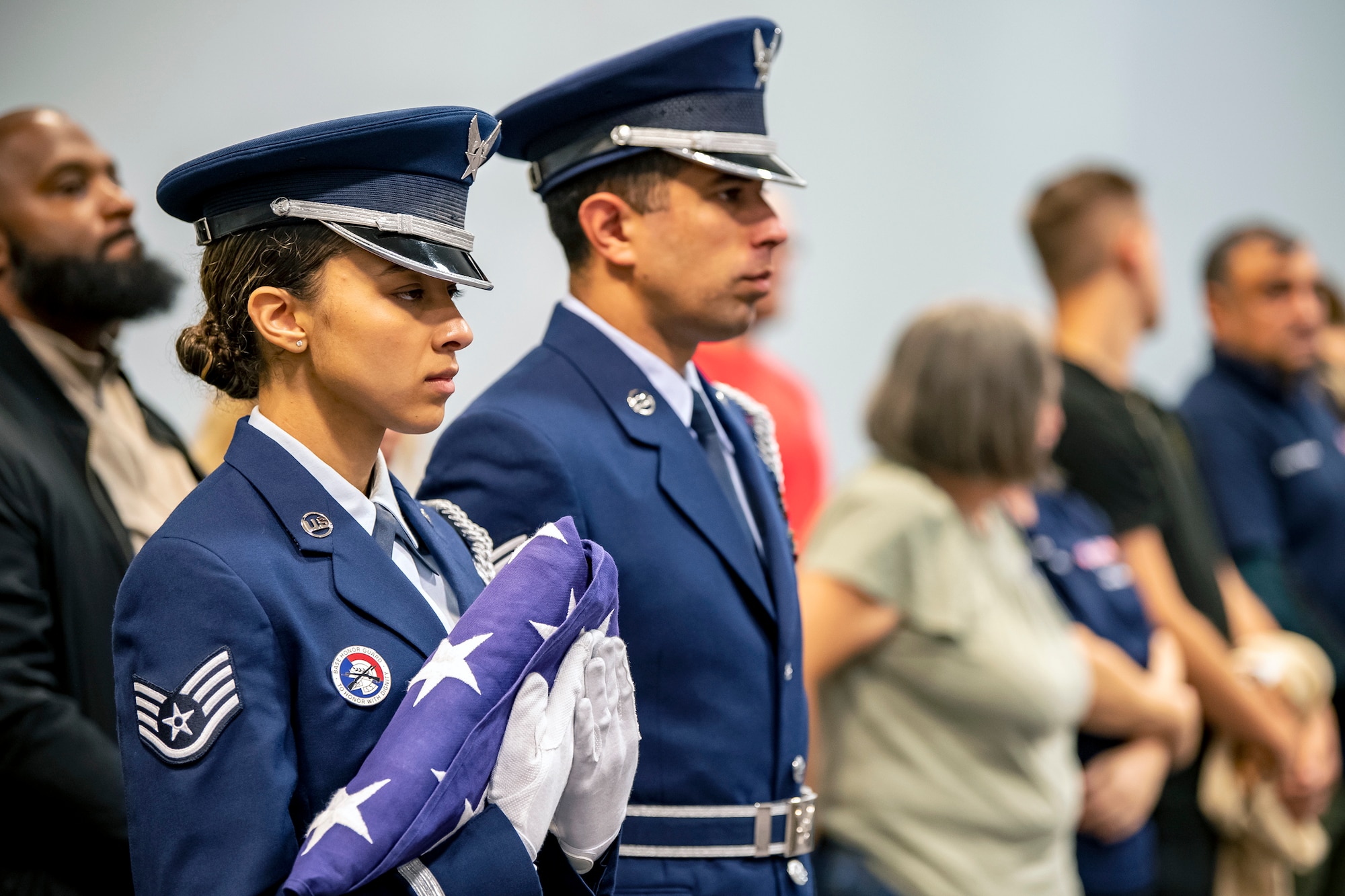 An Airman from the 422d Air Base Group honor guard, holds a folded flag during a 9/11 retreat ceremony at RAF Croughton, England, Sep. 9, 2022. Airmen and guests participated in the ceremony to honor those who lost their lives during the September 11th terrorist attacks. (U.S. Air Force photo by Staff Sgt. Eugene Oliver)