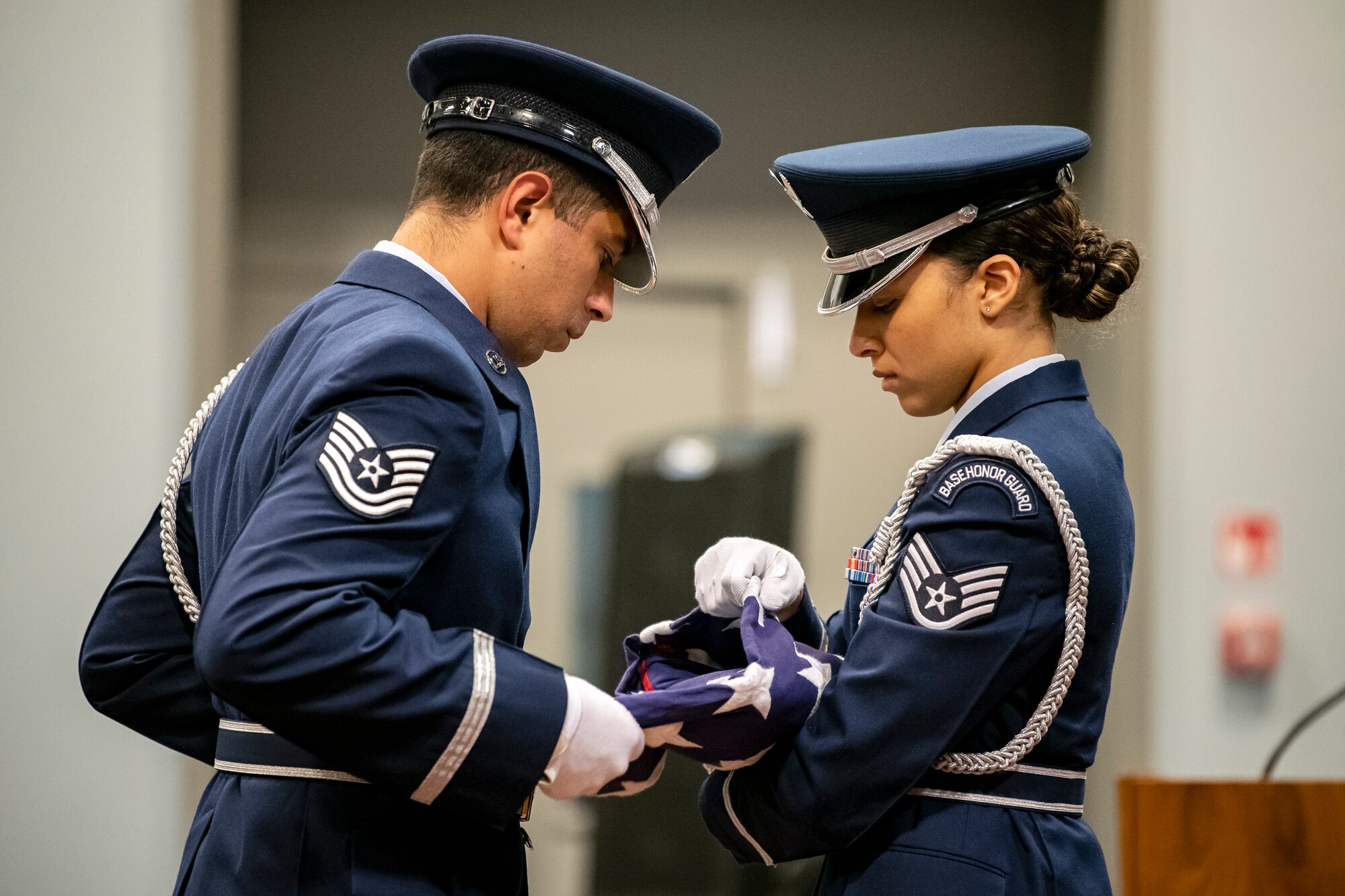 Airmen from the 422d Air Base Group honor guard, fold a flag during a 9/11 retreat ceremony at RAF Croughton, England, Sep 9, 2022. Airmen and guests participated in the ceremony to honor those who lost their lives during the September 11th terrorist attacks. (U.S. Air Force photo by Staff Sgt. Eugene Oliver)