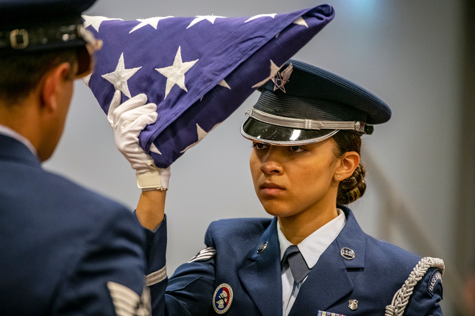 An Airman from the 422d Air Base Group honor guard, holds a folded flag during a 9/11 retreat ceremony at RAF Croughton, England, Sep. 9, 2022. Airmen and guests participated in the ceremony to honor those who lost their lives during the September 11th terrorist attacks. (U.S. Air Force photo by Staff Sgt. Eugene Oliver)