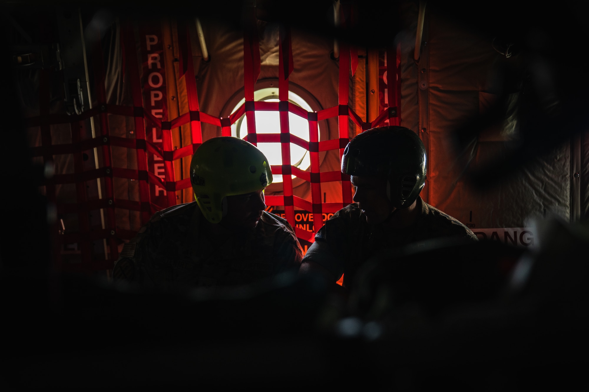 U.S. Marine Corps Capt. Jason Stewart, U.S. Marine Corps Forces, Central Command G-6 operations officer, right, speaks with his son, Senior Airman Cameron Stewart, Air Force Special Operations Command administrator, on an HC-130J Combat King II aircraft assigned to the 920th Rescue Wing, Patrick Space Force Base, Florida, over Tampa, Florida, Sept. 1, 2022.