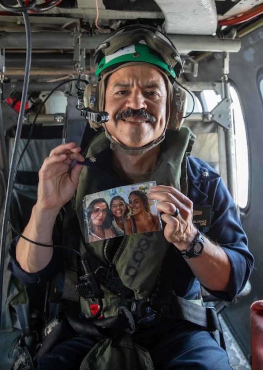 (Aug. 31, 2022) Cmdr. Miles Alvarez, assigned to the the George H.W. Bush Carrier Strike Group (GHWBCSG), is promoted to commander during a promotion ceremony aboard an MH-60S Nighthawk helicopter attached to Helicopter Sea Combat Squadron (HSC) 5, Aug. 31, 2022. The GHWBCSG is on a scheduled deployment in the U.S. Naval Forces Europe area of operations, employed by U.S. Sixth Fleet to defend U.S., allied and partner interests.