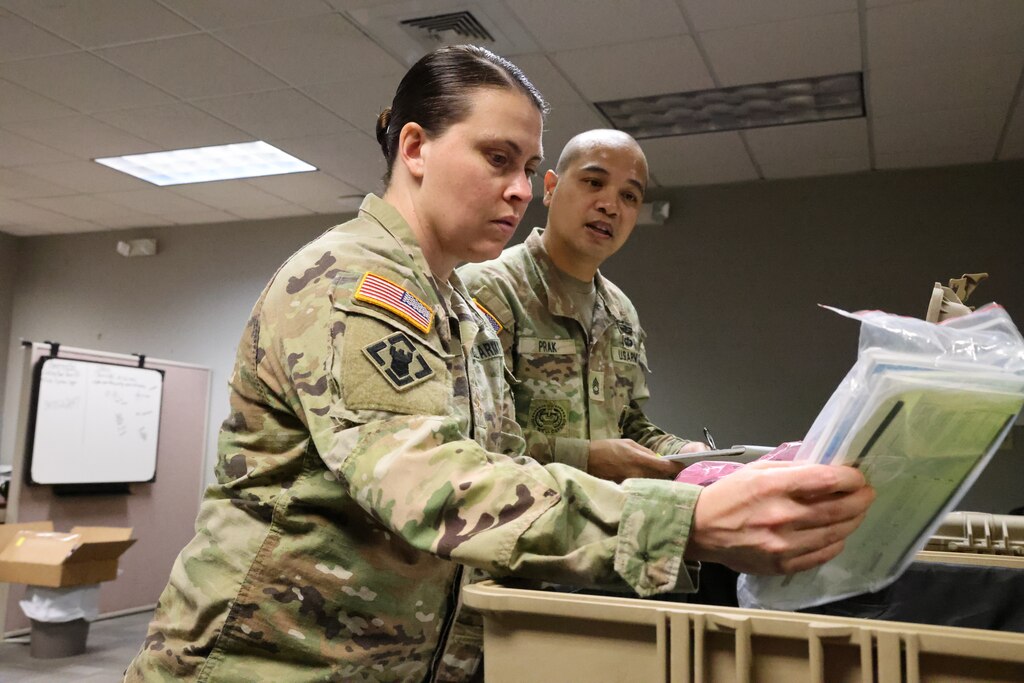 Maj. Kelli Foley, Forward Engineer Support Team-Advance officer in charge, and Sergeant First Class Dandy Prak, Non-Commissioned Officer in Charge, run an equipment check in their office at Mobile, Alabama, Sept. 14, 2022. Foley and Prak were ensuring their equipment is operational for an upcoming deployment. (U.S. Army photo by Chuck Walker)
