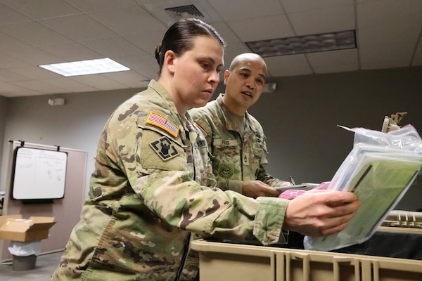 Maj. Kelli Foley, Forward Engineer Support Team-Advance officer in charge, and Sergeant First Class Dandy Prak, Non-Commissioned Officer in Charge, run an equipment check in their office at Mobile, Alabama, Sept. 14, 2022. Foley and Prak were ensuring their equipment is operational for an upcoming deployment. (U.S. Army photo by Chuck Walker)