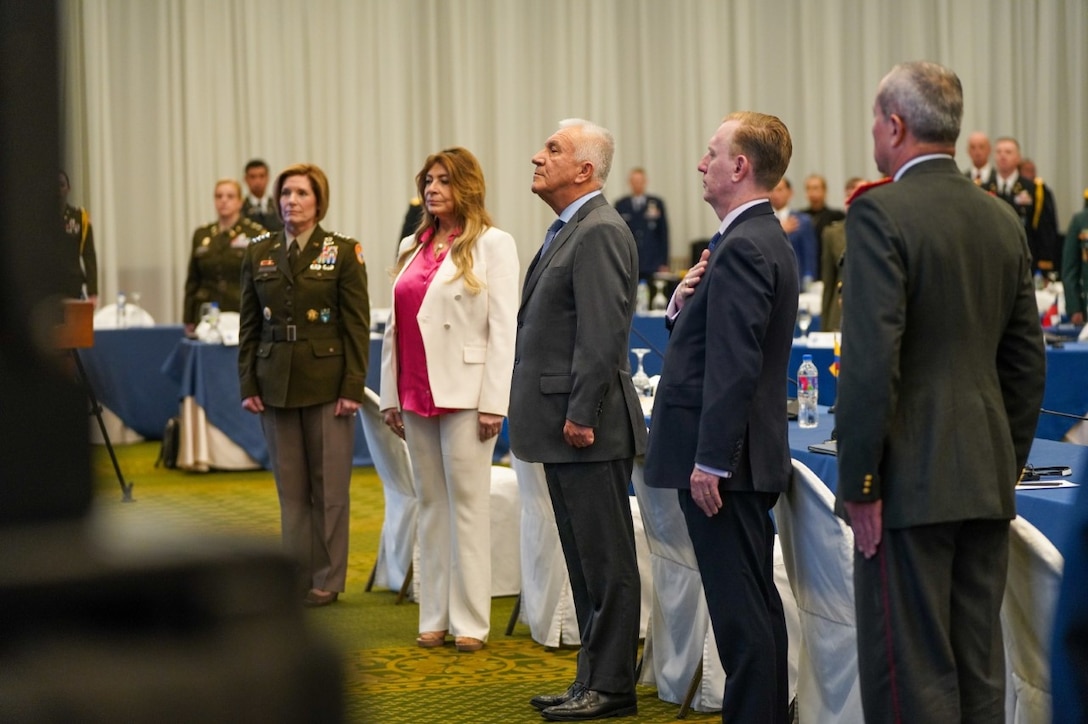 Military leaders stand at attention.