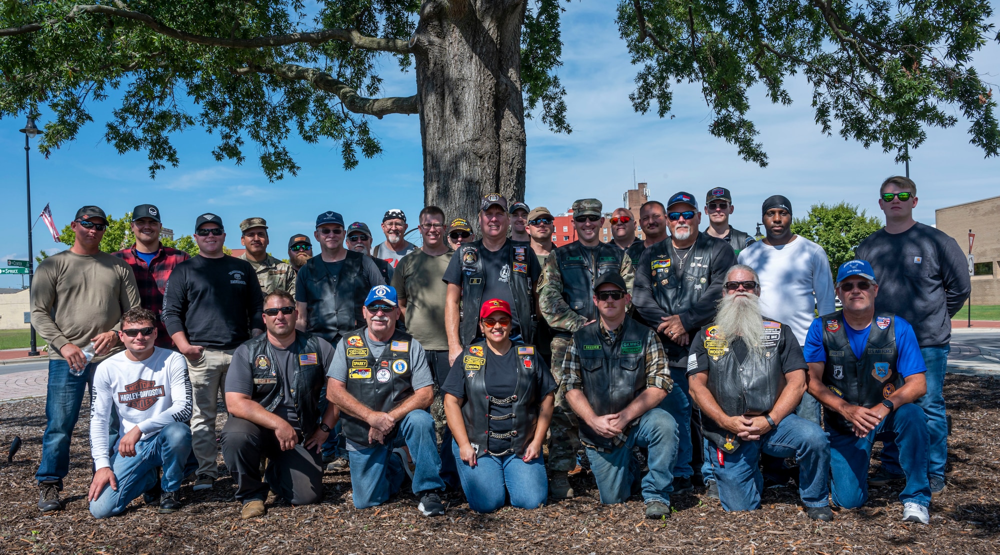 Airmen assigned to Seymour Johnson Air Force Base, veterans, civilians and other military affiliated groups pose in front of the Goldsboro Freedom Tree during POW/MIA Remembrance Week at Goldsboro, North Carolina, September 14, 2022. There are a total of 300 Freedom Trees planted across the country in honor of POW/MIA service members. (U.S. Air Force photo by Airman 1st Class Sabrina Fuller)