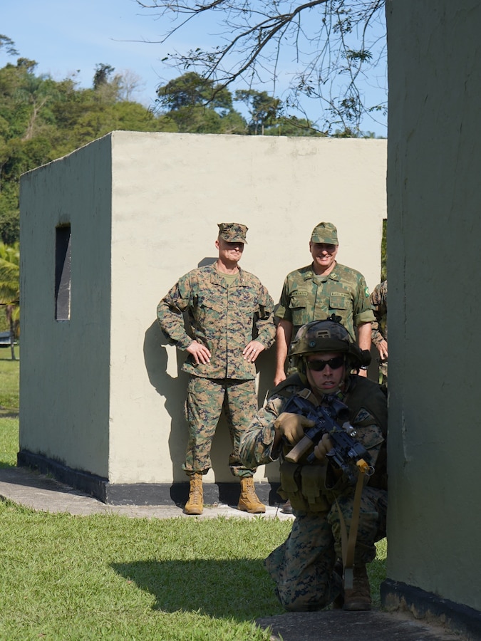 Brig. Gen. Len "Loni" Anderson, aft center, commanding general of 4th Marine Aircraft Wing, Marine Forces Reserve, and Contra-Almirante Marcelo Guimarães Dias (Rear Adm. Brazilian Marine Corps), aft right, commander of Brazil’s Amphibious Division, observe U.S. Marines from Lima Company, 3rd Battalion, 25th Marine Regiment, 4th Marine Division, Marine Forces Reserve, alongside their Brazilian Marine counterparts, conduct Military Operations in Urban Terrain (MOUT) training at Ilha do Governador, Rio de Janeiro, Sept. 6, 2022. Infantry Marines from both nations train together to keep their skills, tactics, techniques, procedures, and partnerships sharp throughout UNITAS LXIII. UNITAS, throughout its 63 iterations, has proven to develop and sustain relationships that improve the capacity of our reemerging and enduring maritime partners to achieve common objectives. Additionally, the military-to-military exchanges foster mutual cooperation, understanding, and respect among participating navies and marine corps. (U.S. Marine Corps photo by Maj. Jeremy Wheeler)