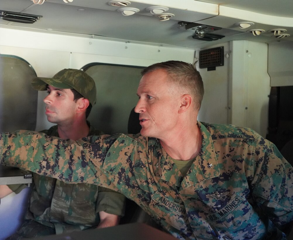 Brig. Gen. Len "Loni" Anderson, right, commanding general of 4th Marine Aircraft Wing, Marine Forces Reserve, discusses communications equipment with a Brazilian marine inside the operational control center of a Brazilian command and control vehicle during a visit with multinational marine forces at Ilha do Governador, Rio de Janeiro, Sept. 6, 2022. UNITAS, which is Latin for ‘unity,’ trains forces from across the globe in South America to conduct joint maritime operations through the execution of anti-surface, anti-submarine, anti-air, amphibious, and electronic warfare operations that enhance warfighting proficiency and increase interoperability among participating navy and marine forces. (U.S. Marine Corps photo by Maj. Jeremy Wheeler)