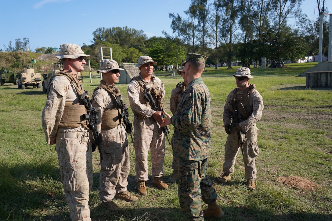 Brig. Gen. Len "Loni" Anderson, commanding general of 4th Marine Aircraft Wing, Marine Forces Reserve greets and shakes the hands of, from left, Sgt. Logan Caldwell, Cpl. Adrian Avelar, Cpl. Matthew Maine, and Cpl. Benjamin Baker, from Delta Company, 4th Light Armor Reconnaissance Battalion (LAR), 25th Marine Regiment, 4th Marine Division, Marine Forces Reserve following a combined, U.S. and Brazilian, training evolution during UNITAS LXIIII at Ilha do Governador, Rio de Janeiro, Sept. 6, 2022.  4th LAR trains side-by-side with Brazilian Marine counterparts as they exchange tactics, techniques, and procedures while building comradery and sharpening relationship throughout Exercise UNITAS LXIII. UNITAS is the world's longest-running annual multinational maritime exercise that brings together forces from 19 countries to include Brazil, Cameroon, Chile, Colombia, Dominican Republic, Ecuador, France, Guyana, Jamaica, Mexico, Namibia, Panama, Paraguay, Peru, South Korea, Spain, the United Kingdom, the United States of America, and Uruguay. The exercise focuses on enhancing interoperability among multiple nations and joint forces during littoral and amphibious operations in order to build on existing regional partnerships and create new enduring relationships that promote peace, stability, and prosperity in the U.S. Southern Command’s area of responsibility. (U.S. Marine Corps photo by Maj. Jeremy Wheeler)