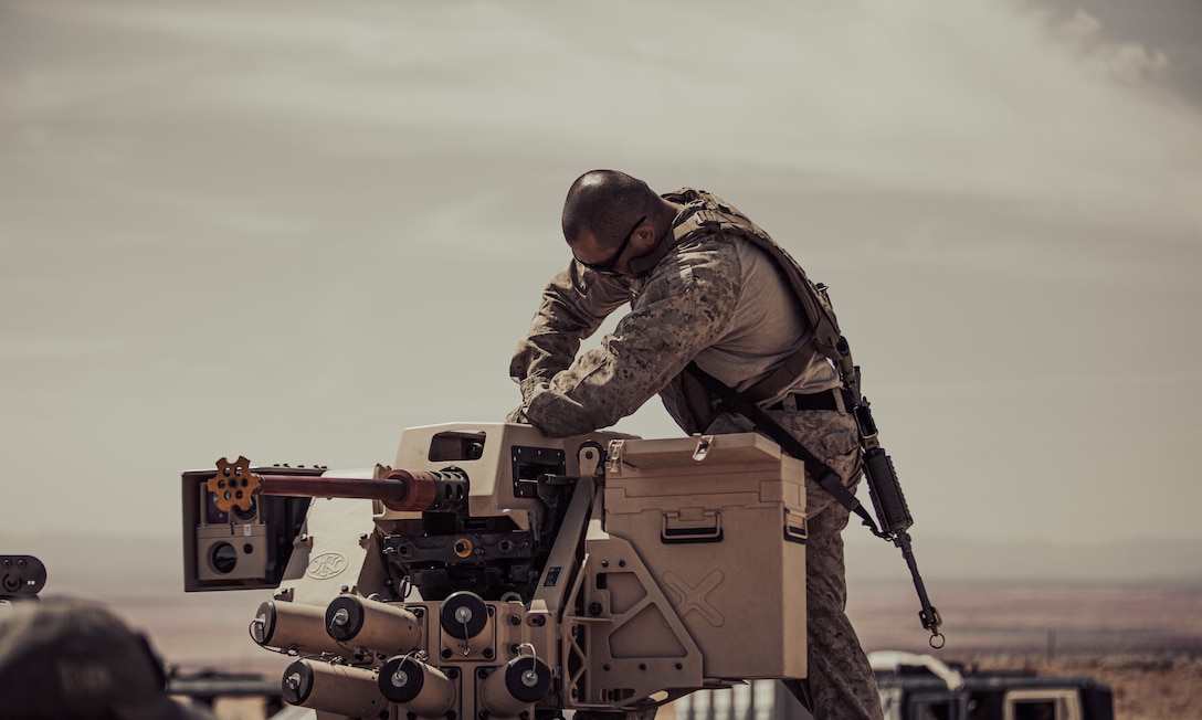 A U.S. Marine services an FLW 200 Remote Weapon Station outfitted with a Browning M2 .50 caliber machine gun