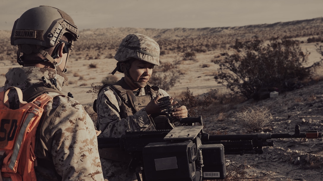 U.S. Marines prepare a small remote-controlled all-terrain vehicle