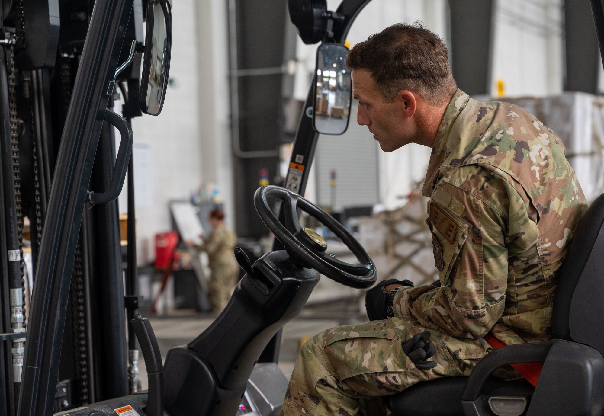 Airman 1st Class Walter Blume, 436th Maintenance Squadron electrical and environmental apprentice, operates a forklift at Dover Air Force Base, Delaware, Sept. 9, 2022. Blume is one of several 436th MXS Airmen that augmented at the 436th Aerial Port Squadron to help alleviate their recent 300% mission surge. The augmentation implements Gen. Charles Q. Brown Jr. 's “Accelerate Change or Lose” action order  by utilizing multi-capable Airmen. (U.S. Air Force photo by Senior Airman Cydney Lee)