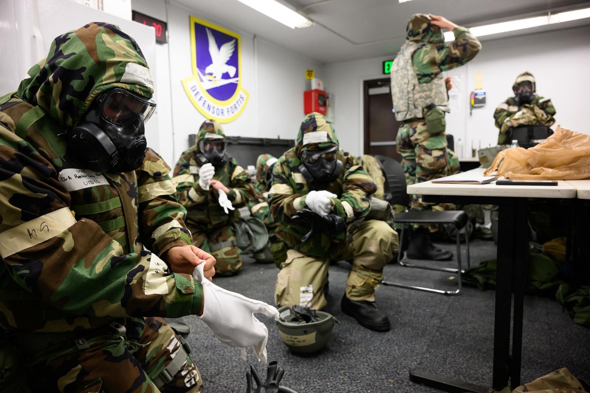 Airmen don protective gear during a Phase 2 exercise at Hill Air Force Base, Utah, Sept. 14, 2022.