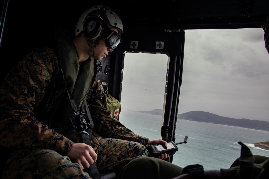 U.S. Marine Corps Lance Cpl. Jeramy Martin, a communications data system administrator attached to Marine Light Attack Helicopter Squadron (HMLA) 773, 4th Marine Aircraft Wing, Marine Forces Reserve in support of Special Purpose Marine Air-Ground Task Force UNITAS LXIII, maintains communication channels during flight operations near the Christ the Redeemer statue at Corcovado Mountain, Rio de Janeiro, during exercise UNITAS LXIII, Sept. 12, 2022. UNITAS, which is Latin for “unity,” was conceived in 1959 and has taken place annually since first conducted in 1960. This year marks the 63rd iteration of the world’s longest-running annual multinational maritime exercise. Additionally, this year Brazil celebrated its bicentennial, a historical milestone commemorating 200 years of the country’s independence. Martin is a native of Orlando, FL. (U.S. Marine Corps photo by Cpl. Colton K. Garrett)