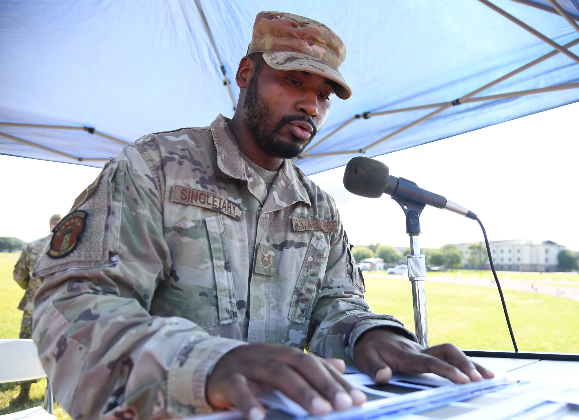 U.S. Air Force Tech. Sgt. Arthur Singletary, 85th Engineering Installation Squadron vehicle operations NCO in charge, reads the names of those who were prisoners of war or are missing in action during the POW/MIA run and vigil at the triangle track on Keesler Air Force Base, Mississippi, Sept. 16, 2022. The event, hosted by the Air Force Sergeants Association Chapter 652, is held annually to raise awareness and pay tribute to all prisoners of war and the military members still missing in action. (U.S. Air Force photo by Kemberly Groue)