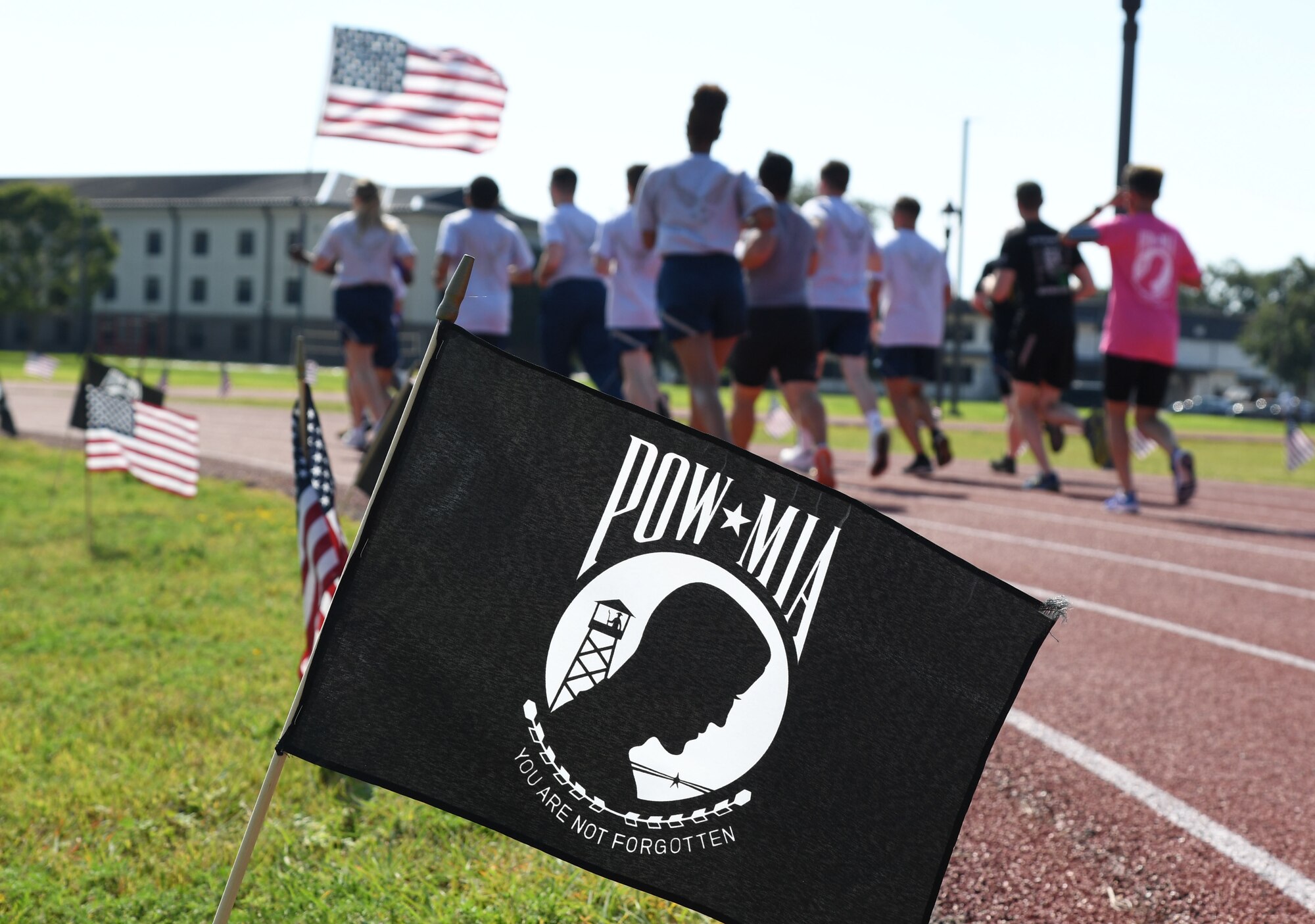 Keesler personnel participate in the POW/MIA run and vigil at the triangle track on Keesler Air Force Base, Mississippi, Sept. 16, 2022. The event, hosted by the Air Force Sergeants Association Chapter 652, is held annually to raise awareness and pay tribute to all prisoners of war and the military members still missing in action. (U.S. Air Force photo by Kemberly Groue)
